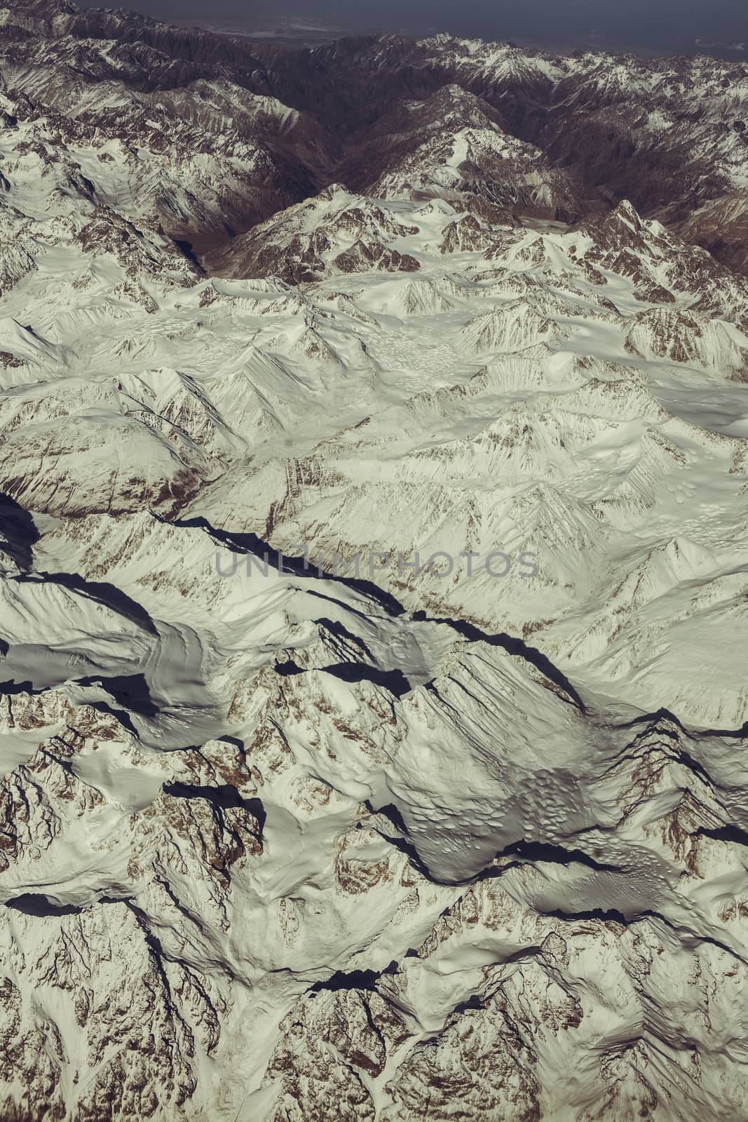 Mountain range, beautiful snowy mountains. View from the airplane