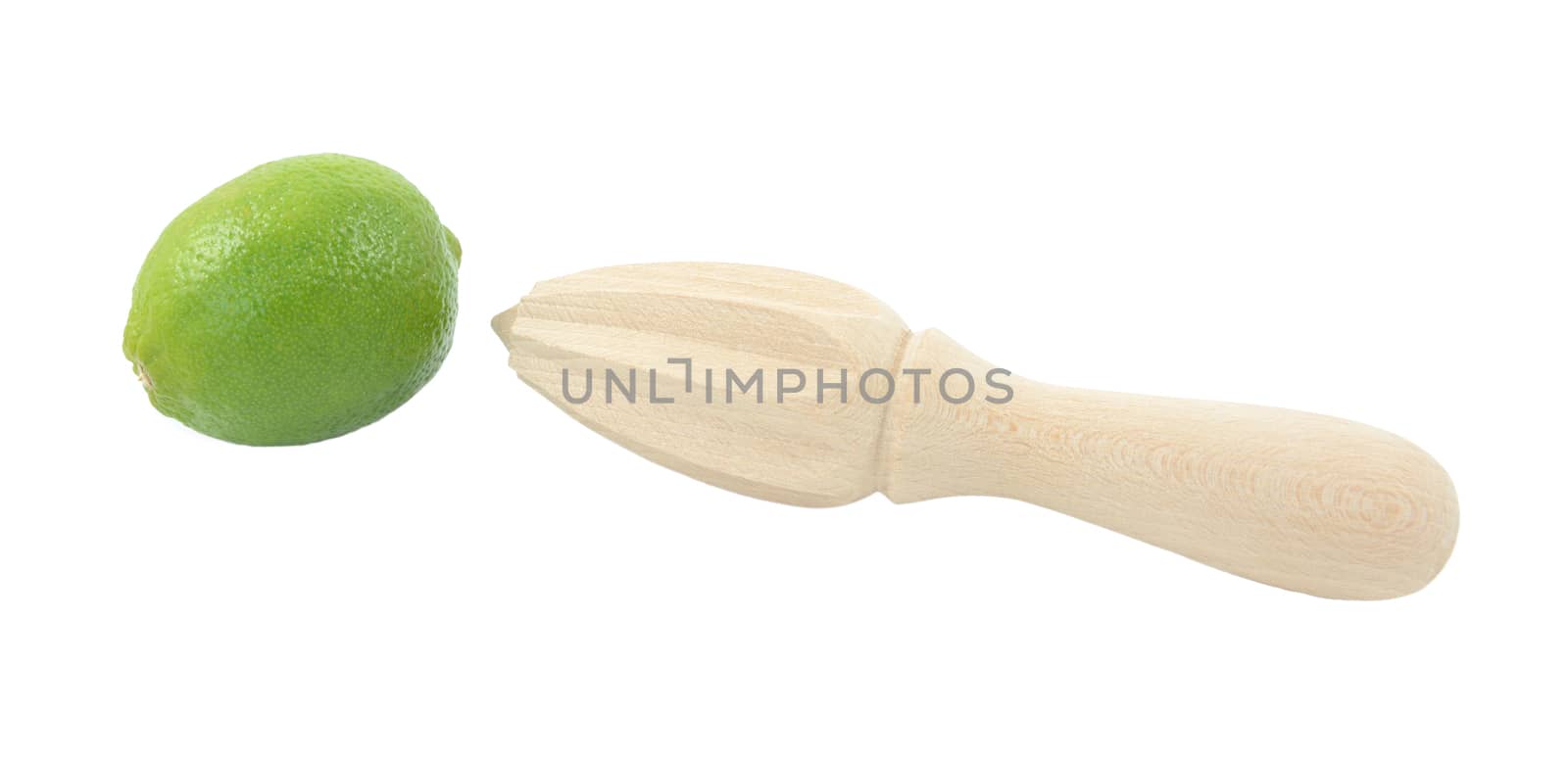Whole lime and wooden citrus reamer, isolated on a white background