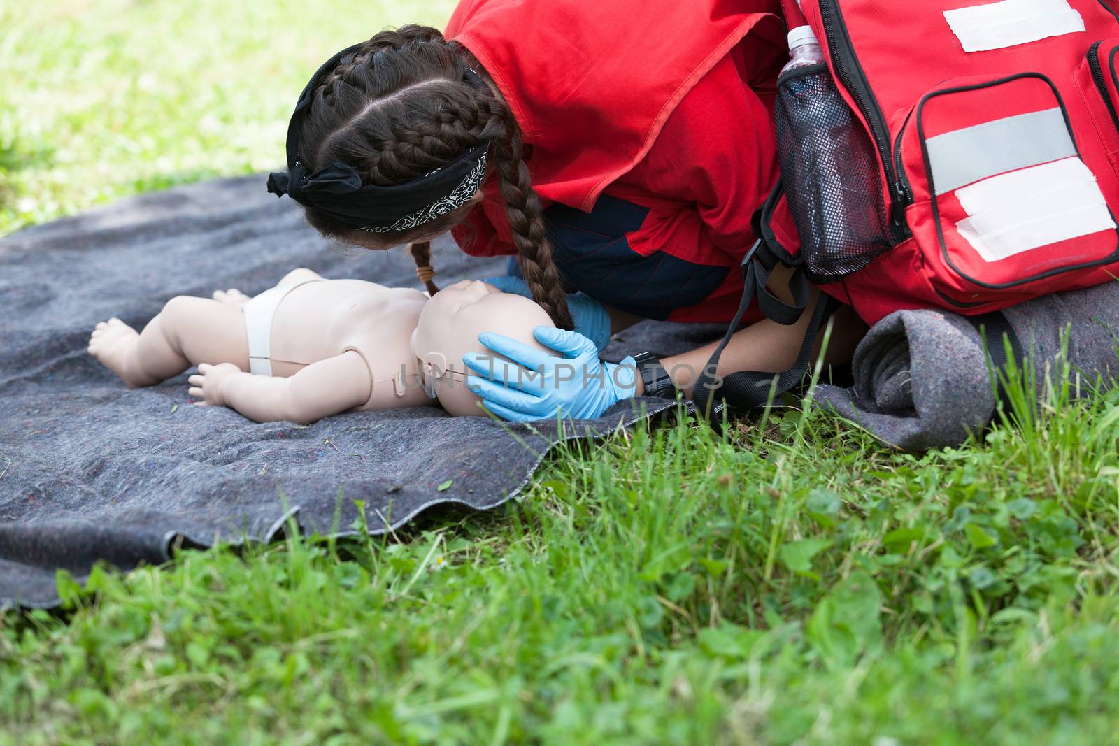 Paramedic demonstrate Cardiopulmonary resuscitation (CPR) on baby dummy by wellphoto