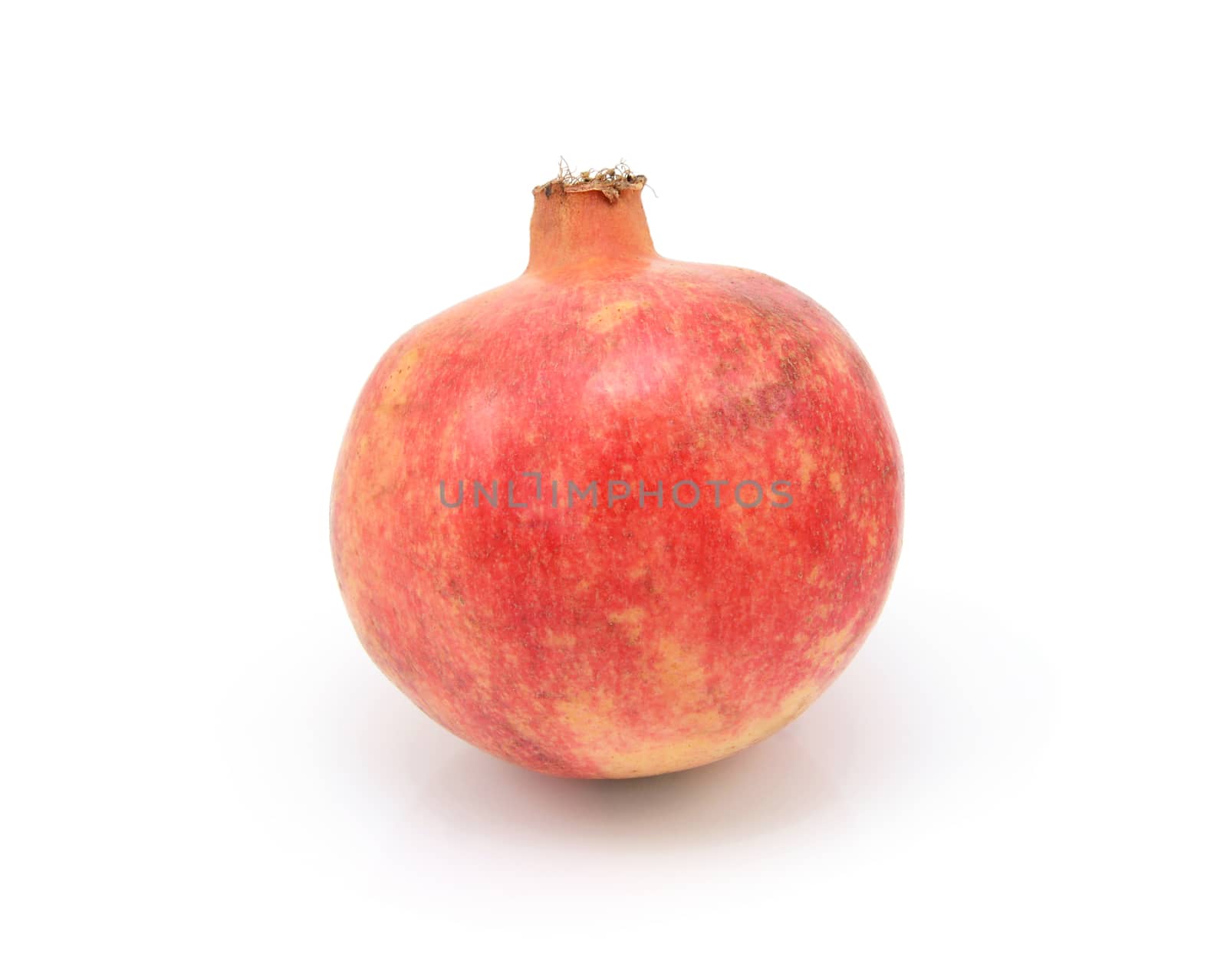 Whole pomegranate, with tough red and yellow skin, isolated on a white background