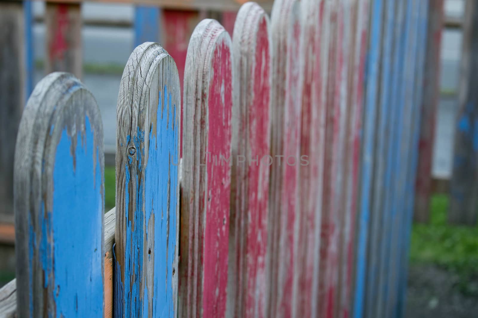 An old colored wooden fence in a playground