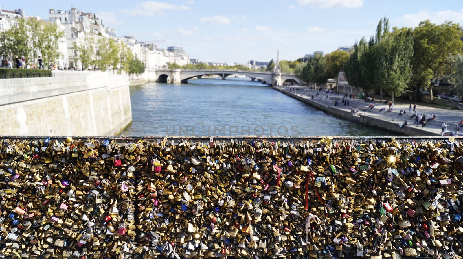 PARIS, FRANCE - SEPTEMBER 27, 2015: Many love locks at the Archbishop's (Pont de l'Archeveche) bridge in Paris, France