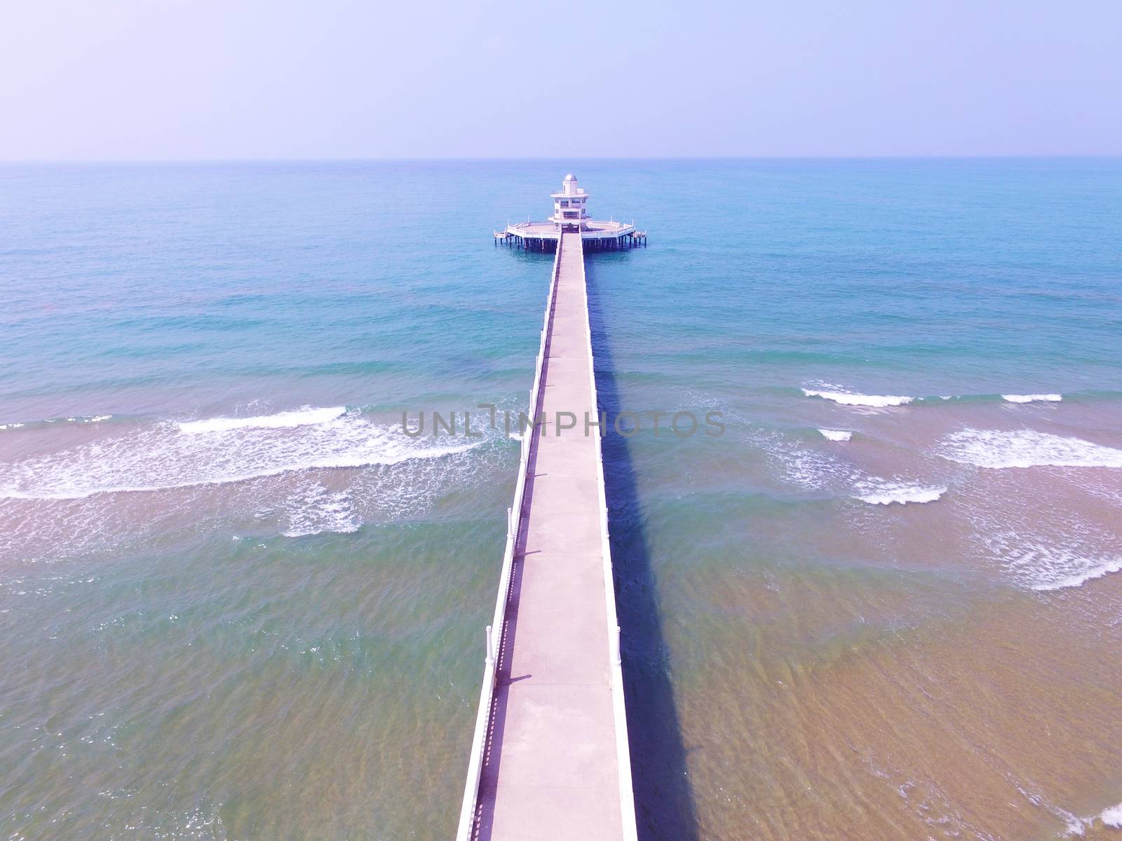 aerial  view of light house pier and blue sea beach by khunaspix