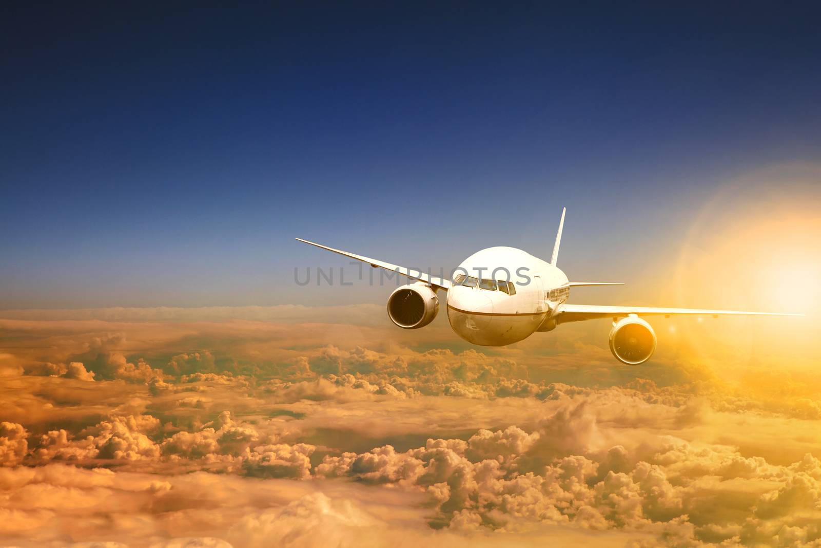 air plane flying over cloud scape and sun light behind