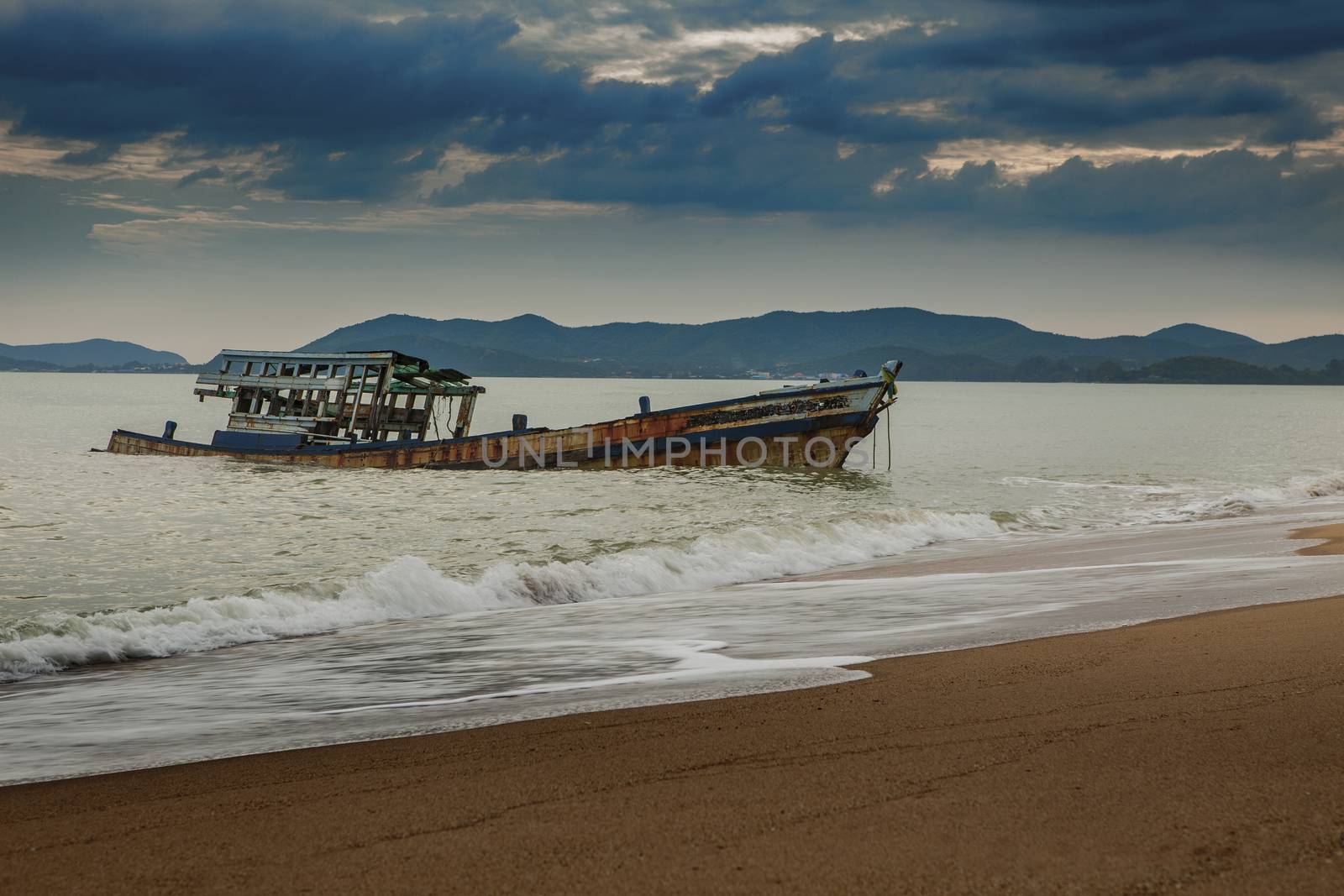sea scape of wreck boat on beach by khunaspix