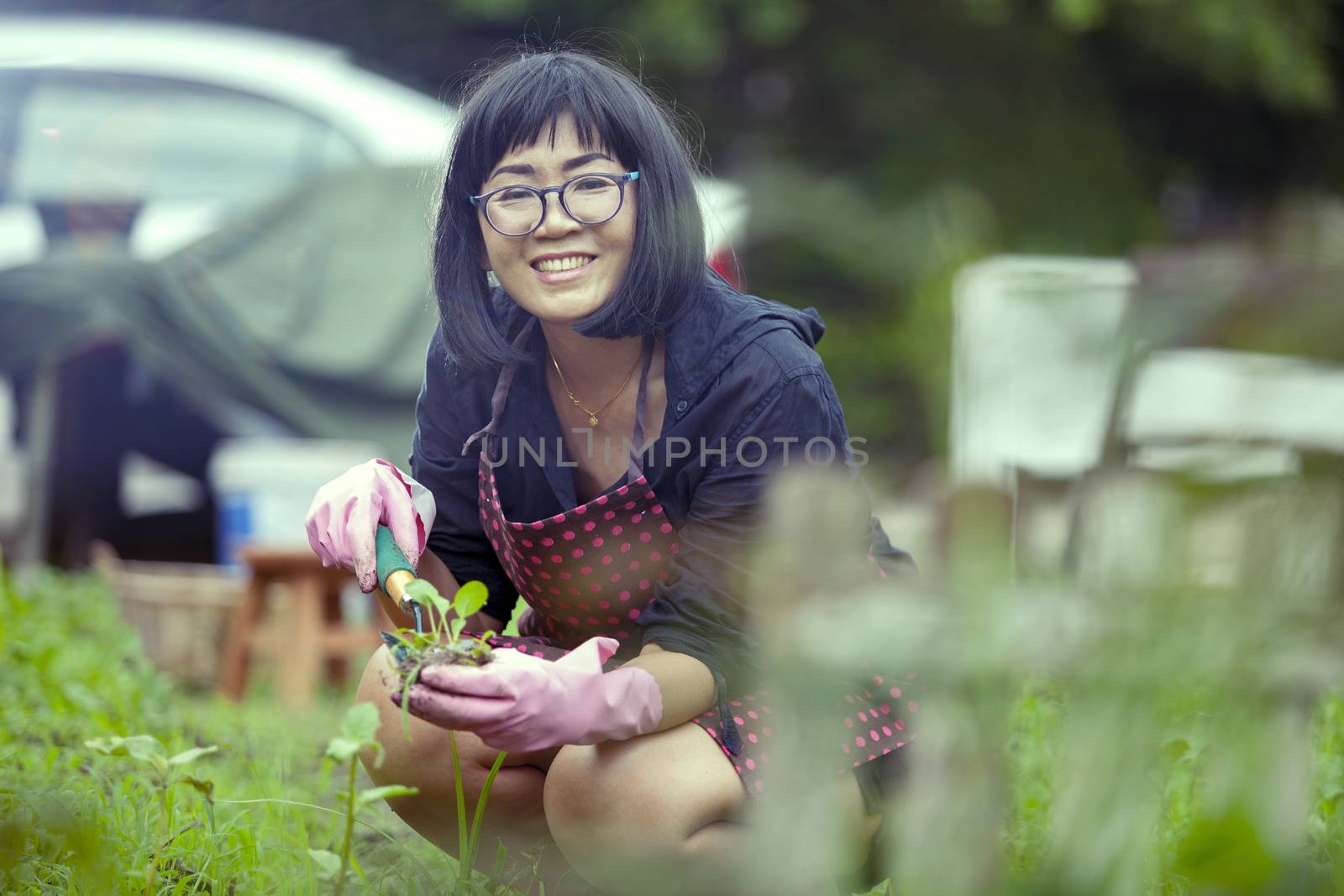 asian woman relaxing happiness emotion planting organic vegetable in home garden