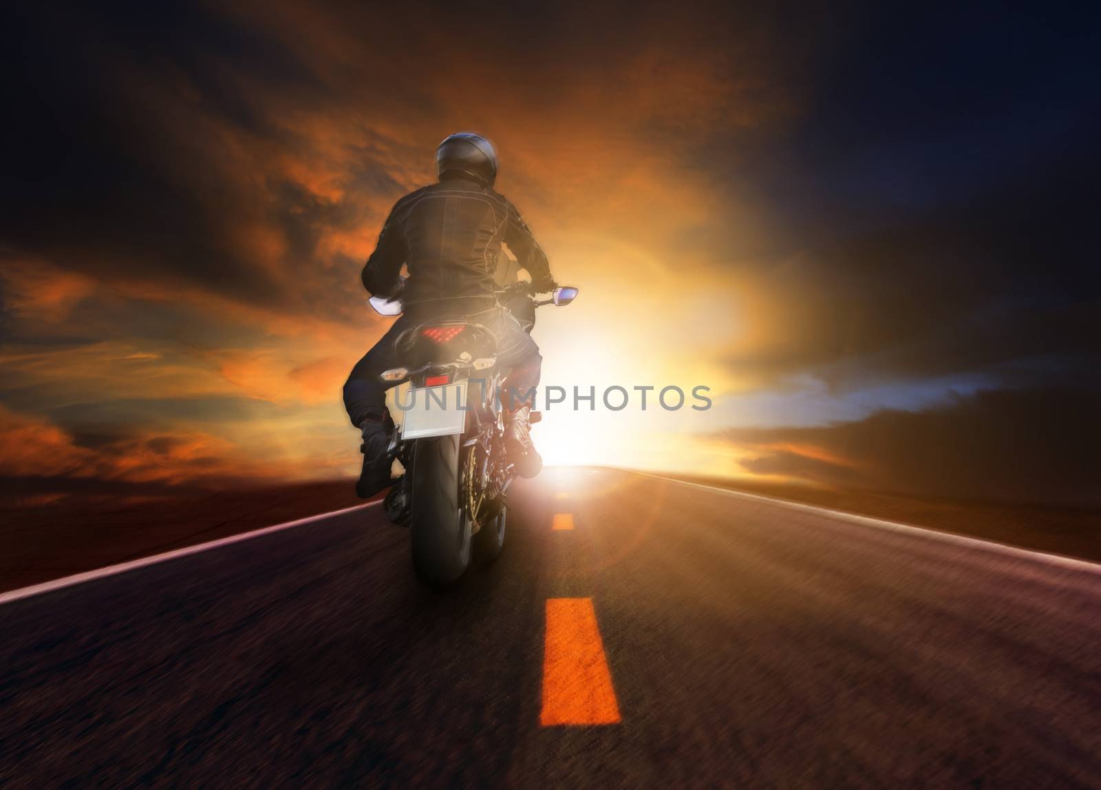 man riding motorcycle on road for traeling lifestyle by khunaspix
