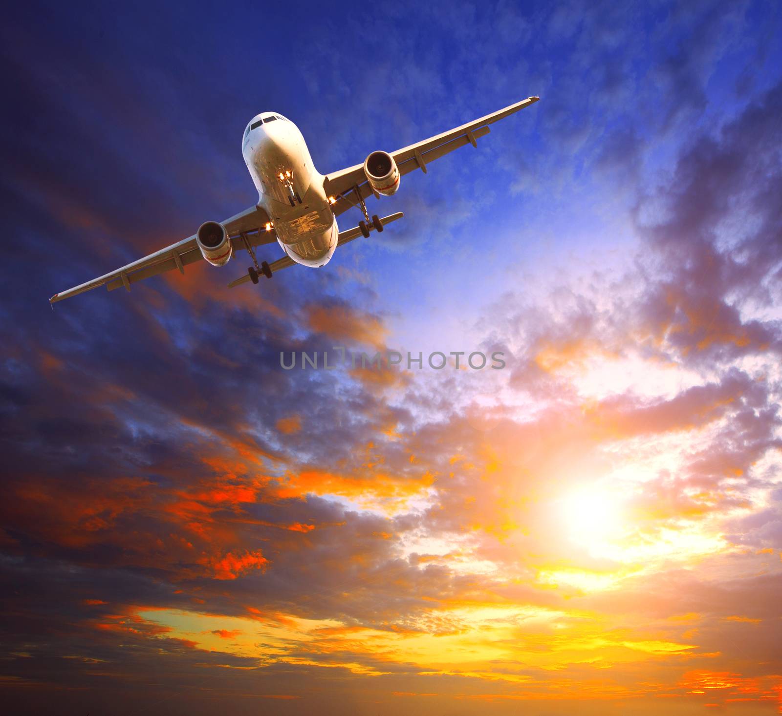 passenger jet plane preparing to landing against beautiful dusky by khunaspix