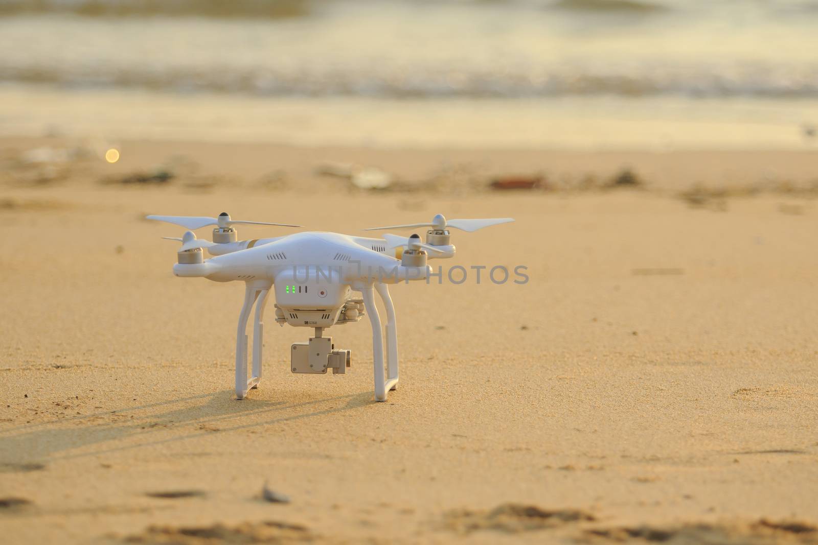 RANONG THAILAND - MARCH 20 : dji phantom 3 pro drone approaching for take off on sea beach on march 20 , 2016 in payam island ranong thailand