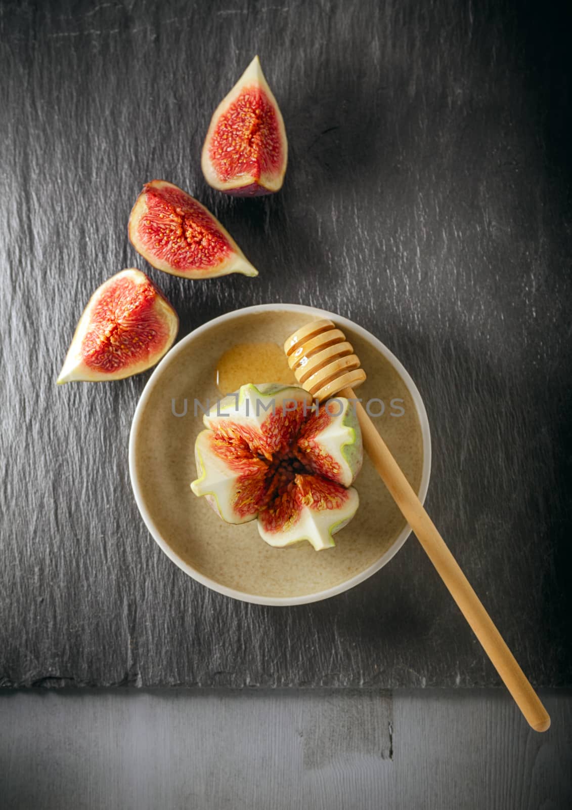 Fresh fig on the plate with honey by supercat67