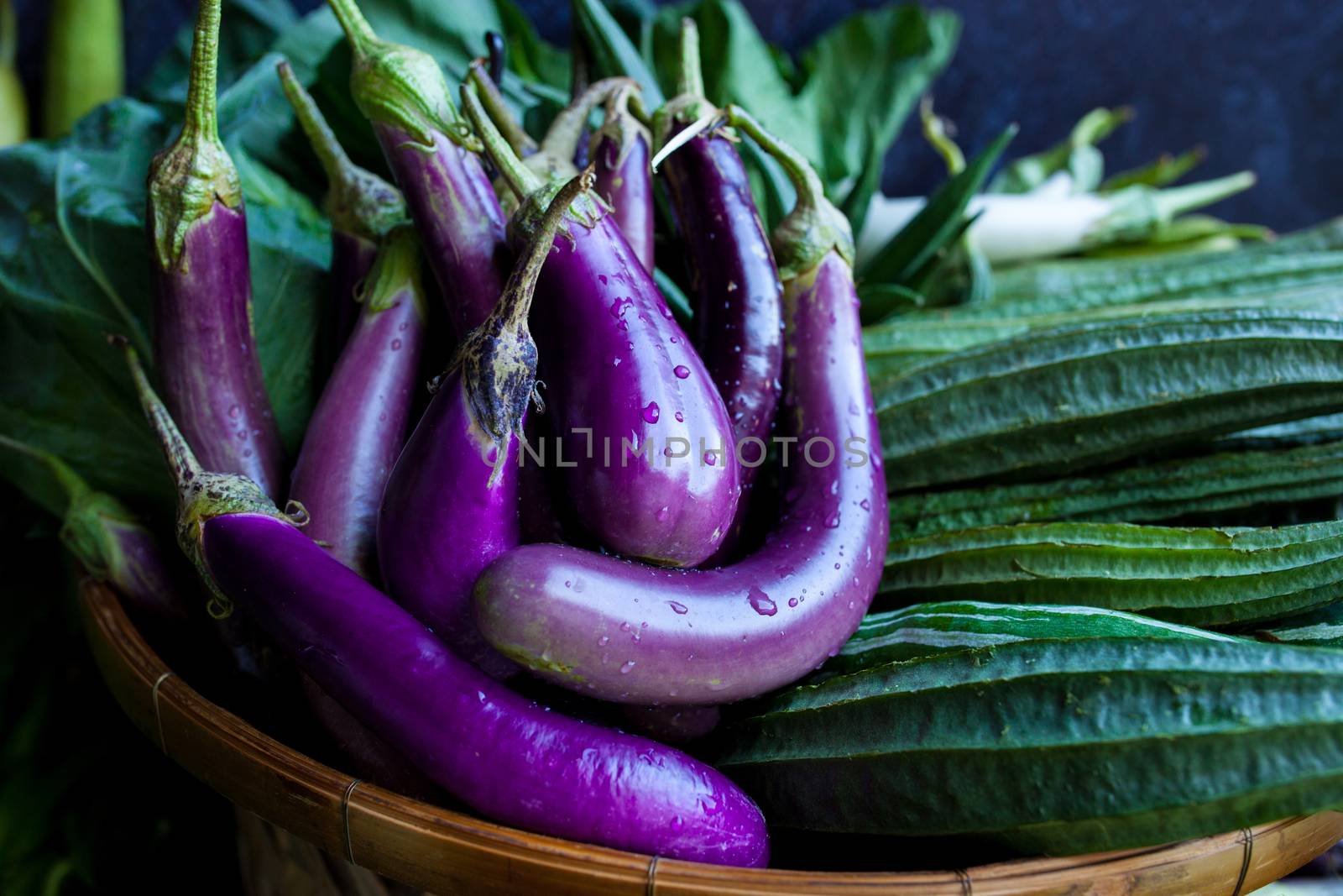 Fresh healthy eggplants on dark background.