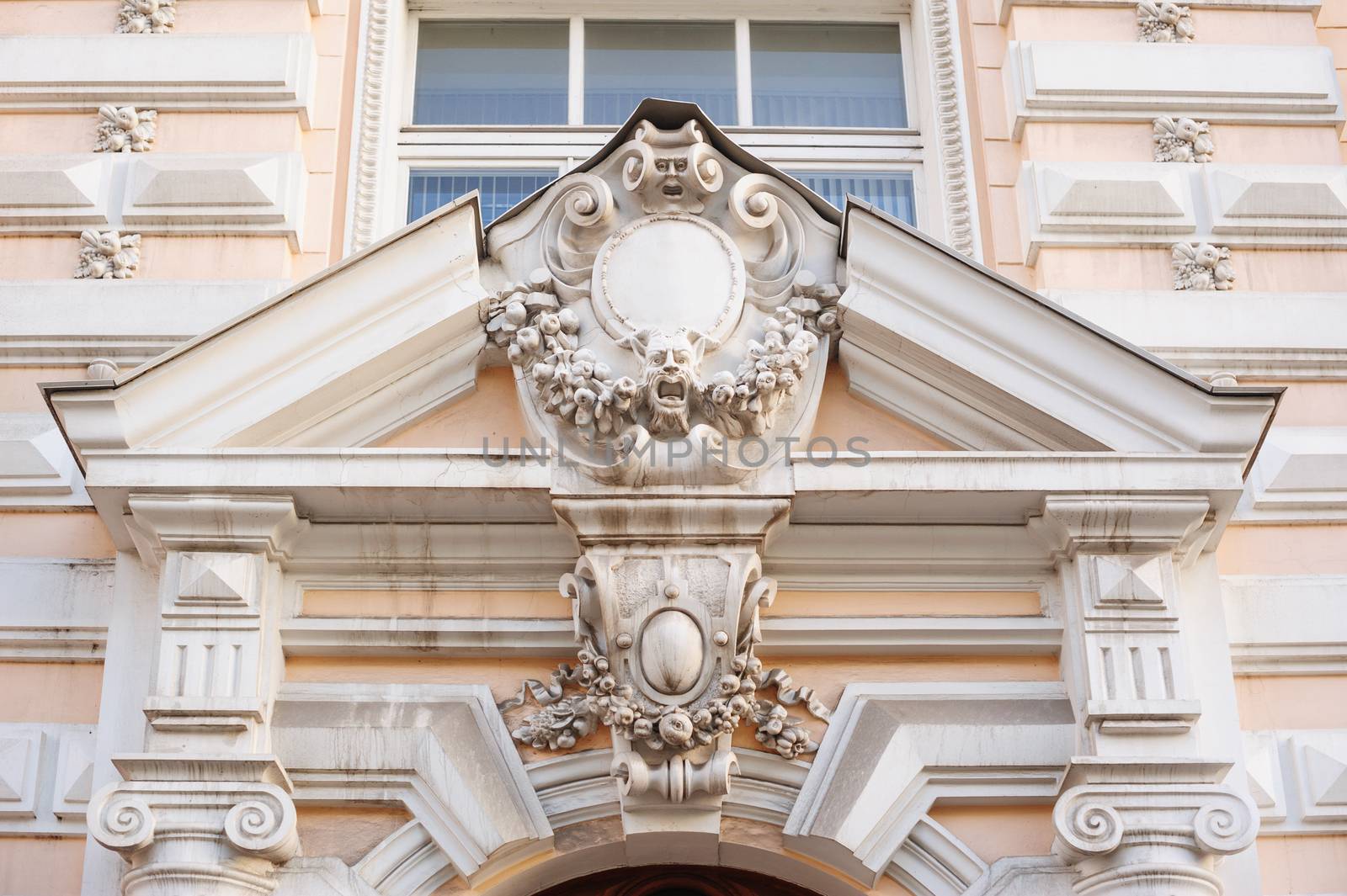 acroteria on the facade of white architectural building.