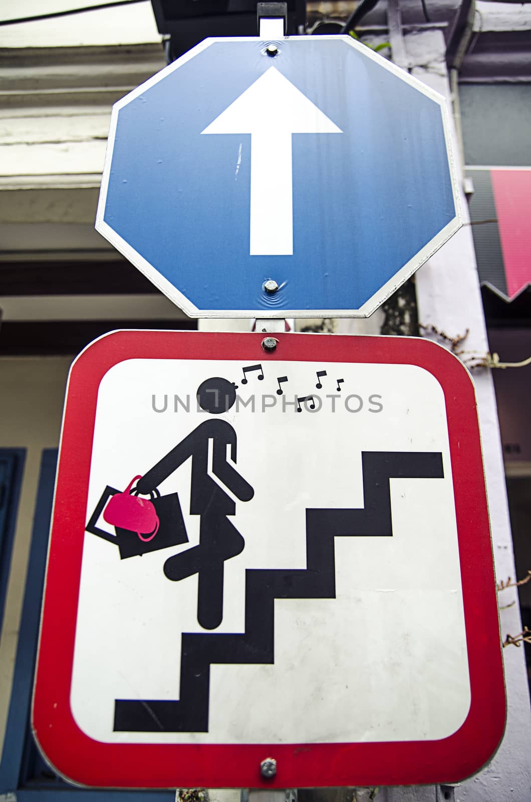 Road sign with glamor woman stair in Singapore