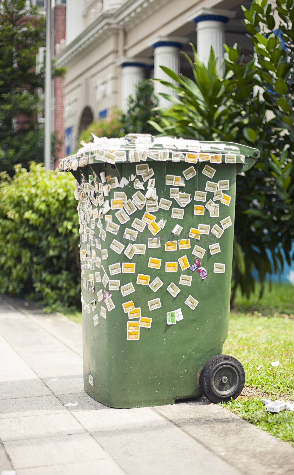 Large green trash box pasted over stickers