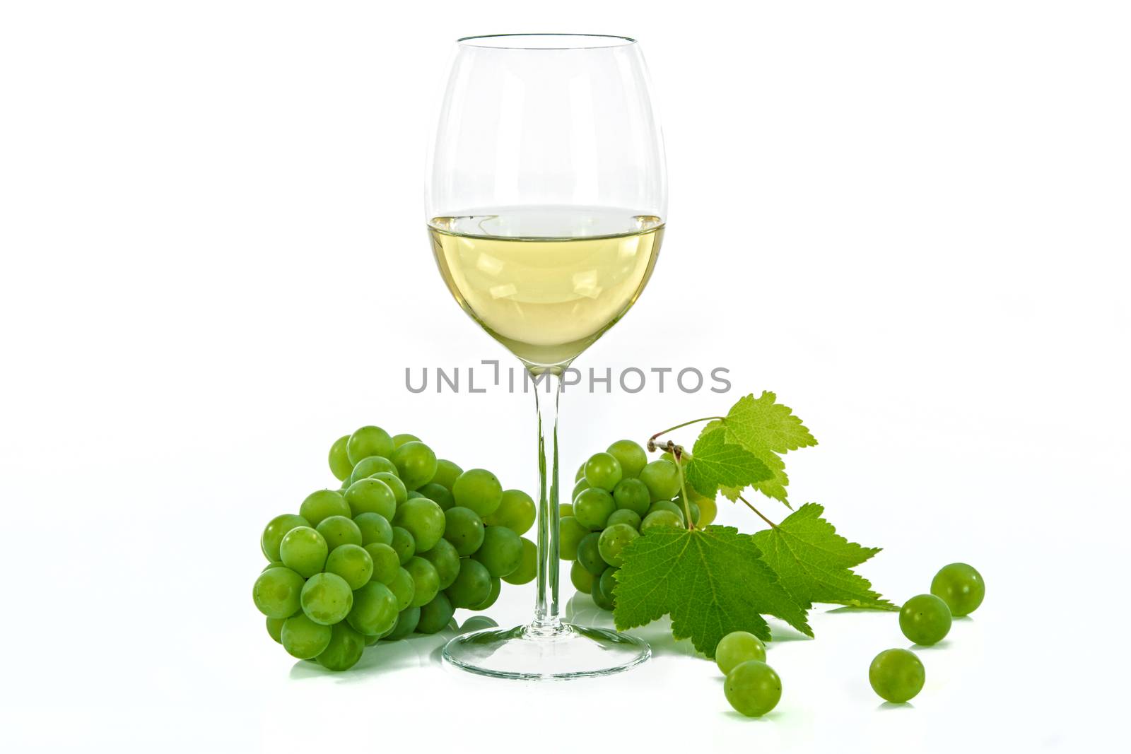 Ripe grapes and wine glass isolated on white
