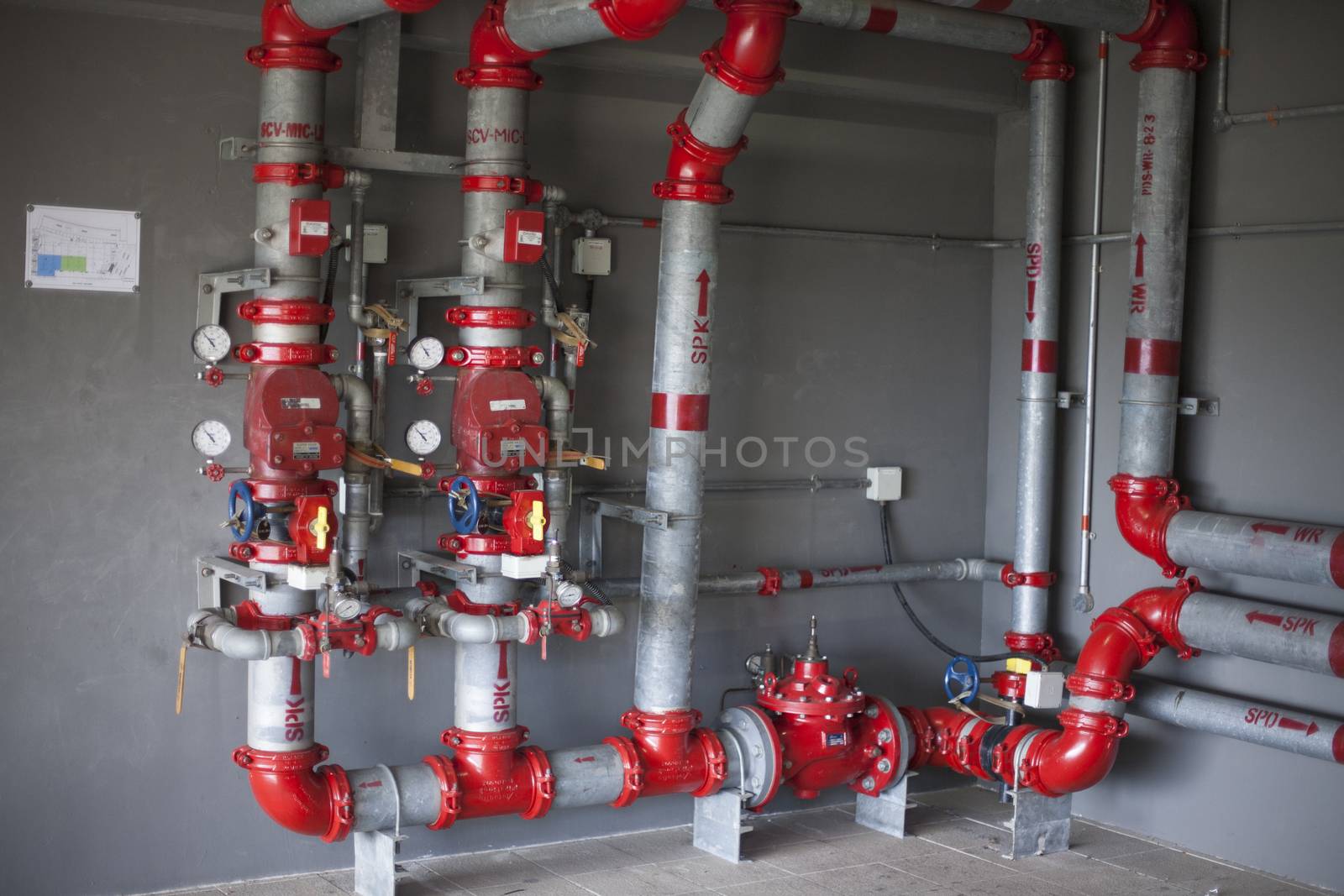 Heating system's cooper pipes with ball valves on a white wall