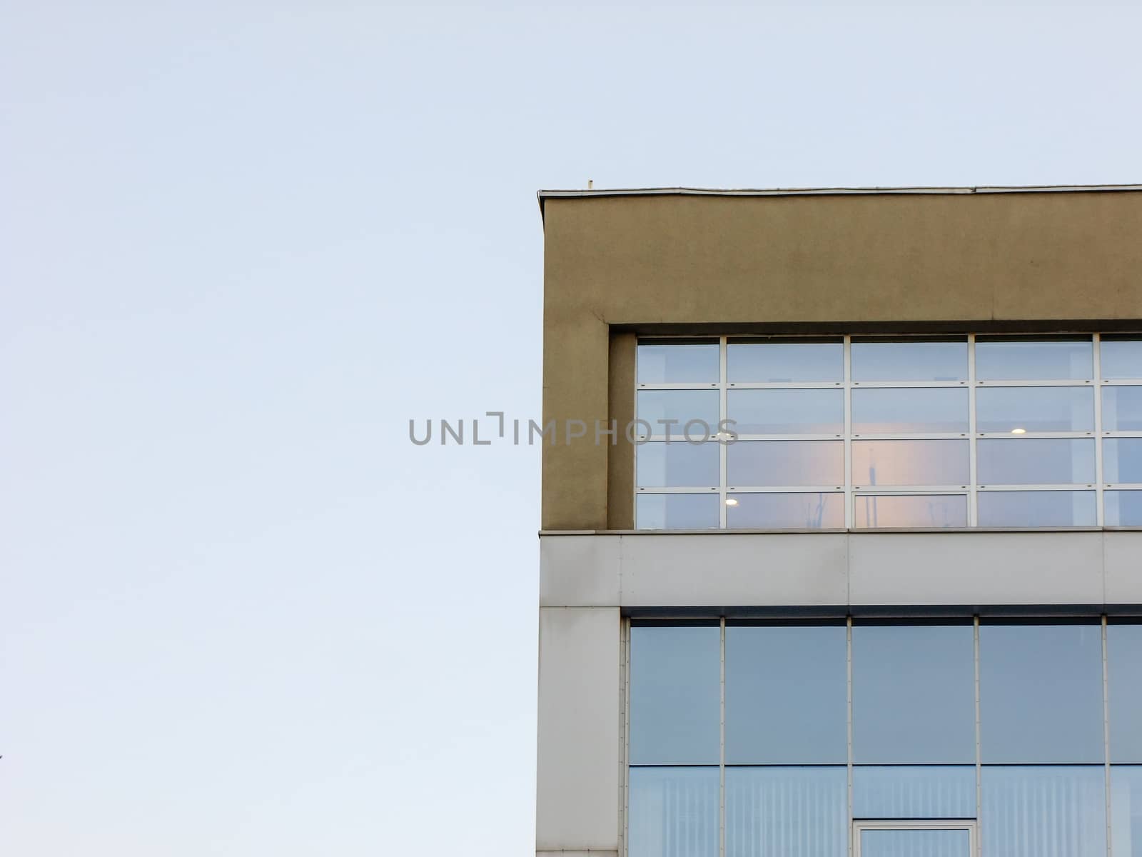 Modern Glass and Concrete Building on the right Side Corner of deep blue Sky Background