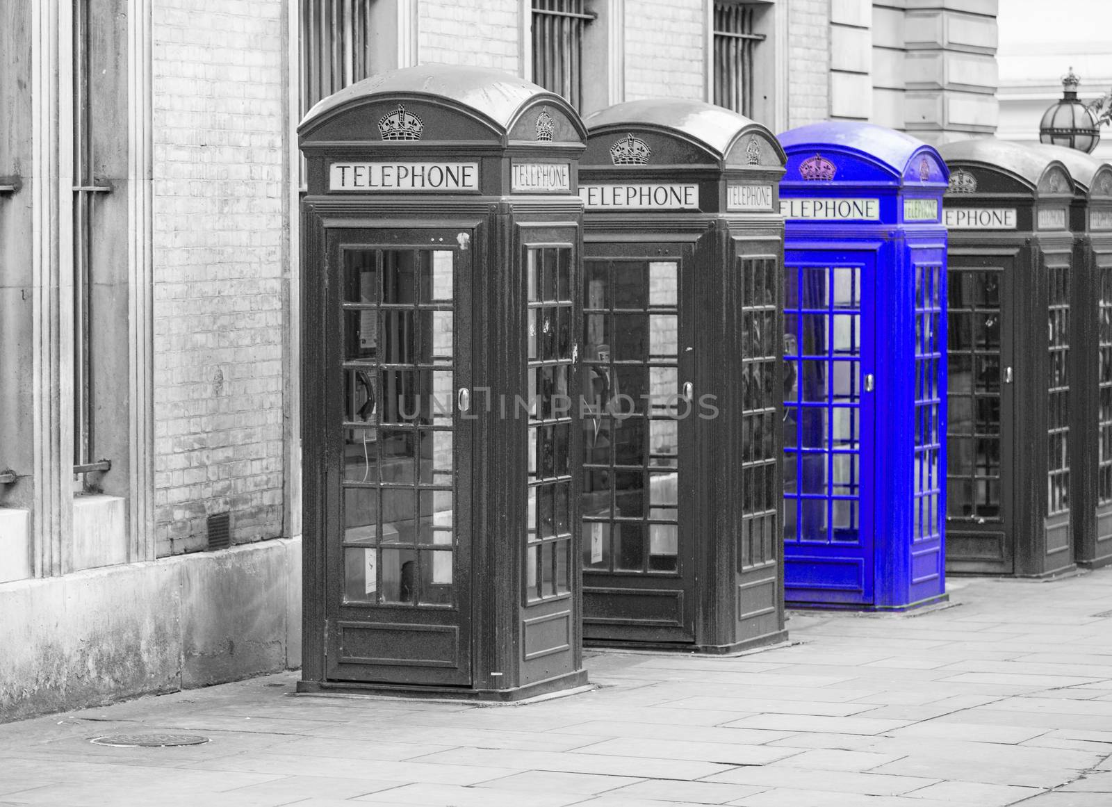 Five Red London Telephone boxes all in a row in the City