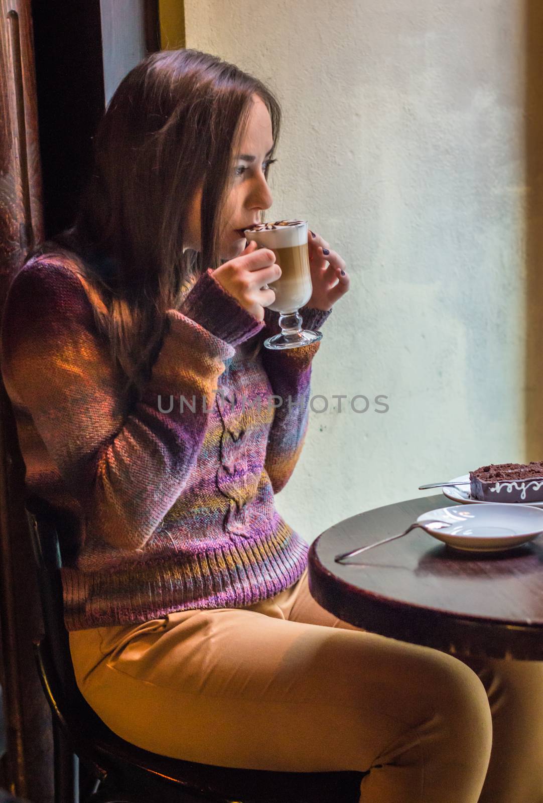 beautiful girl drinking coffee in a cafe