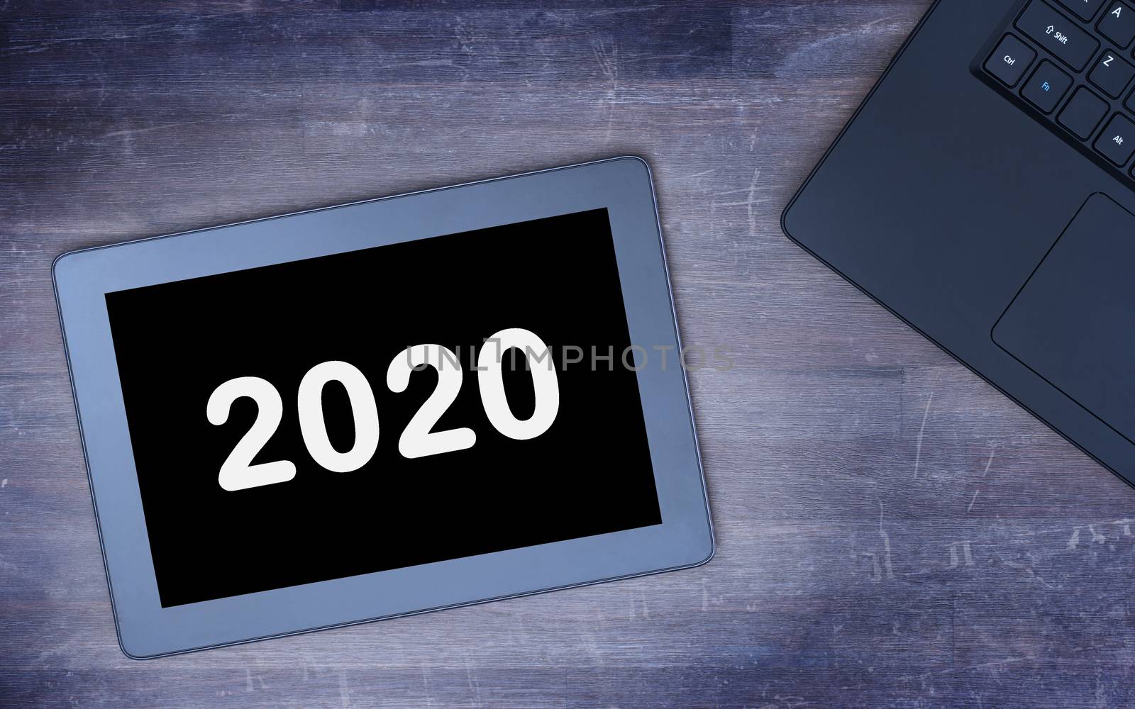 Tablet touch computer gadget on wooden table, vintage look - 2020