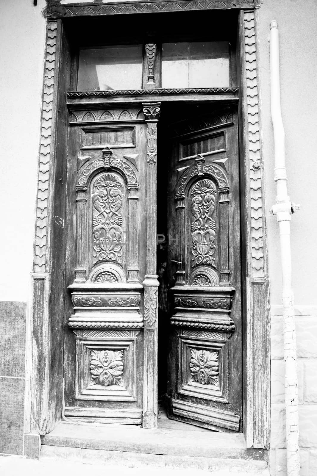 the architecture of the old wooden door with beautiful carvings by Oleczka11