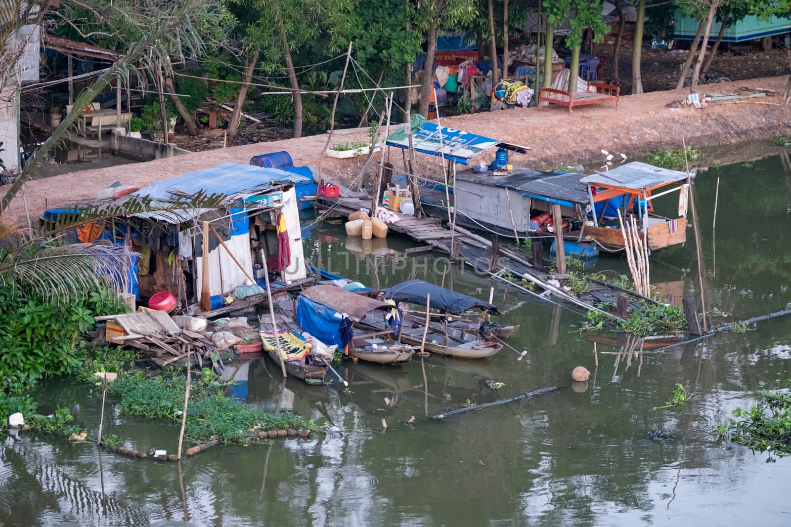 Boats and floating houses in a slum urban area on Sai Gon river. Ho Chi Minh city, VIET NAM
