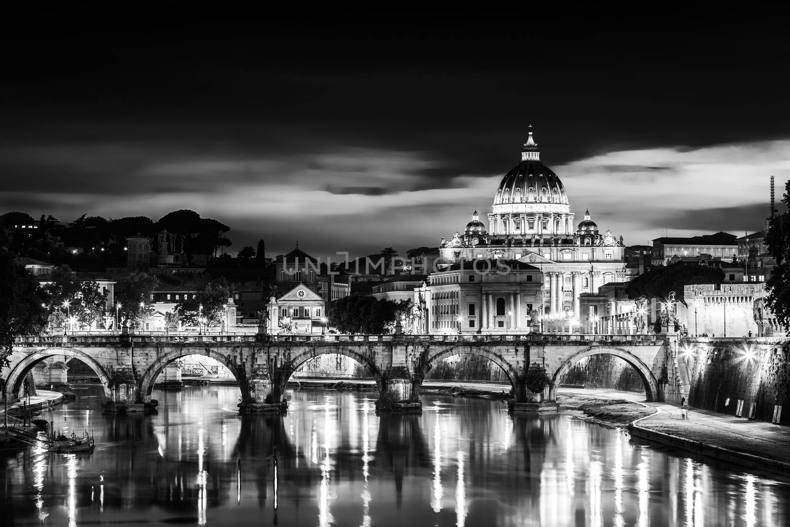 Night view of old roman Bridge of Hadrian and St. Peter's cathedral in Vatican City Rome Italy.