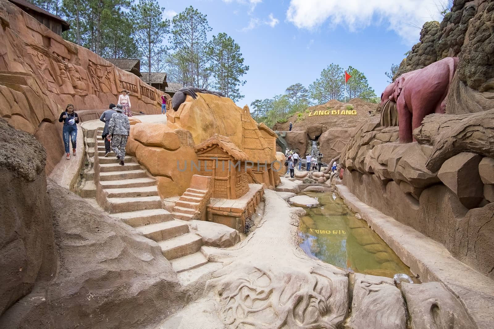 Amazing destination for Vietnam tourism, work of art know as sculpture tunnel from clay, crowd of traveller traveling architecture work in forest