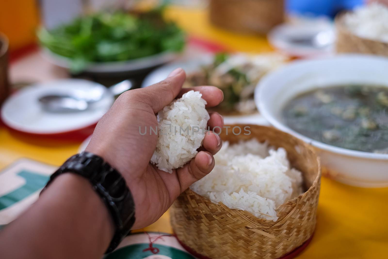 Food container for sticky rice on hand. Vientiane, Lao