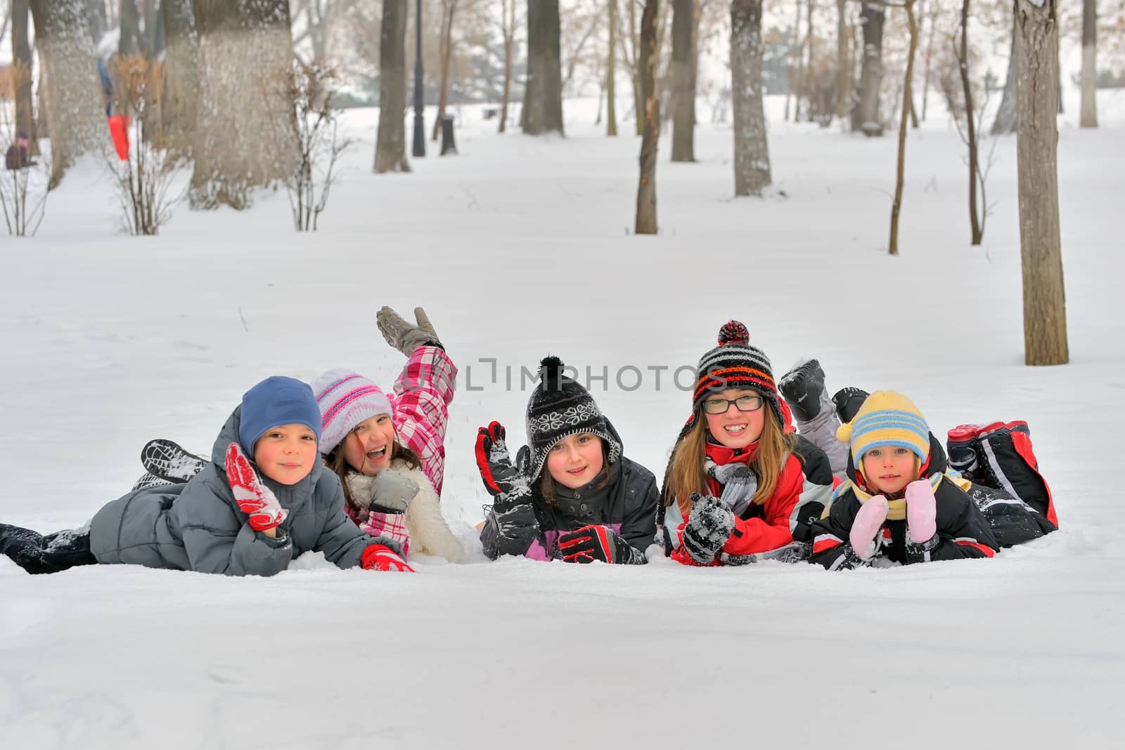 Happy children in winterwear laughing  by jordachelr