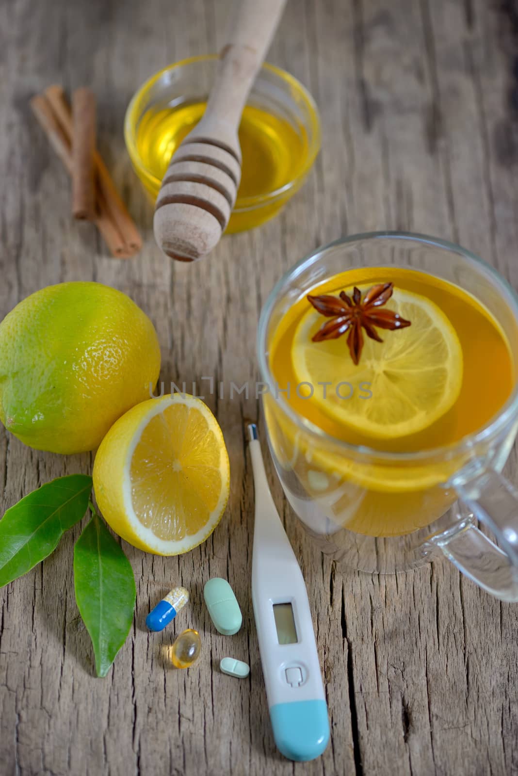 Traditional medicine and flu concept - cup of tea with lemon and honey