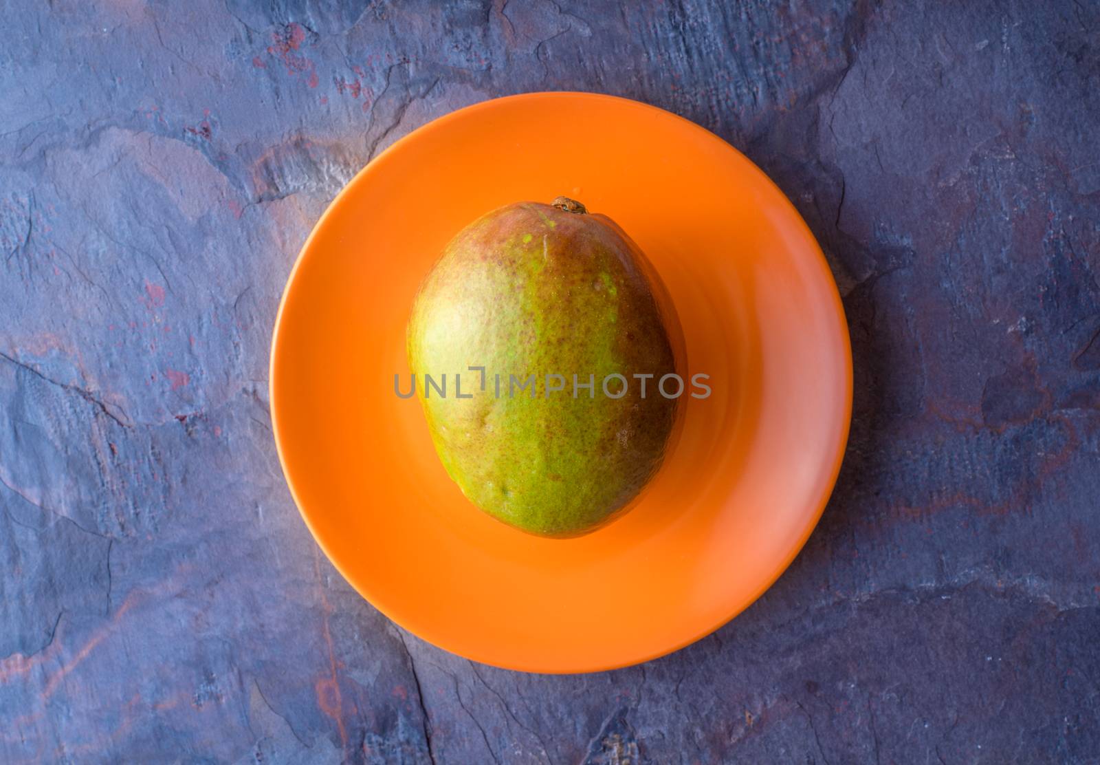 Mango is on the orange plate by Deniskarpenkov