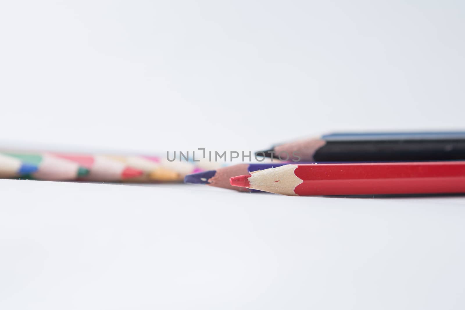 red pencil lies on white background macro