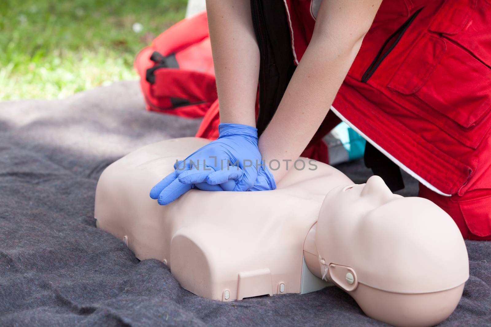 First aid training. Instructor showing CPR on training doll.