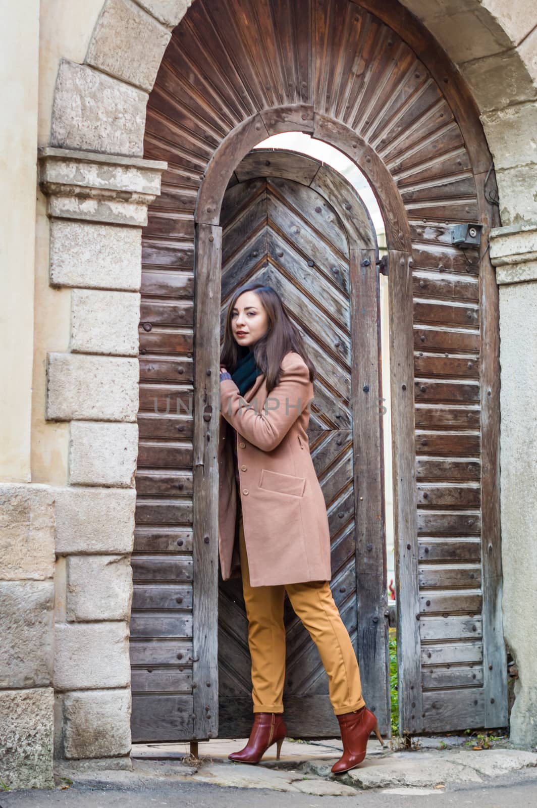 girl near old wooden gate by okskukuruza