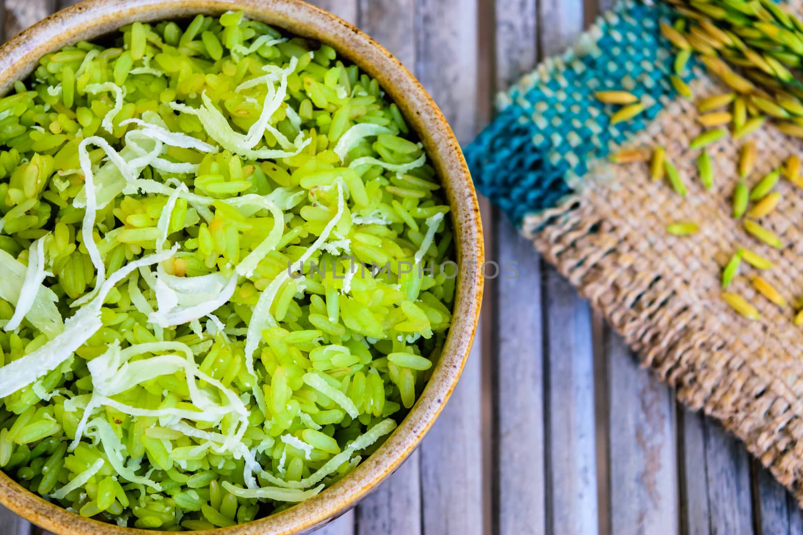 shredded rice grain with coconut, traditional Thai dessert on old wooden table