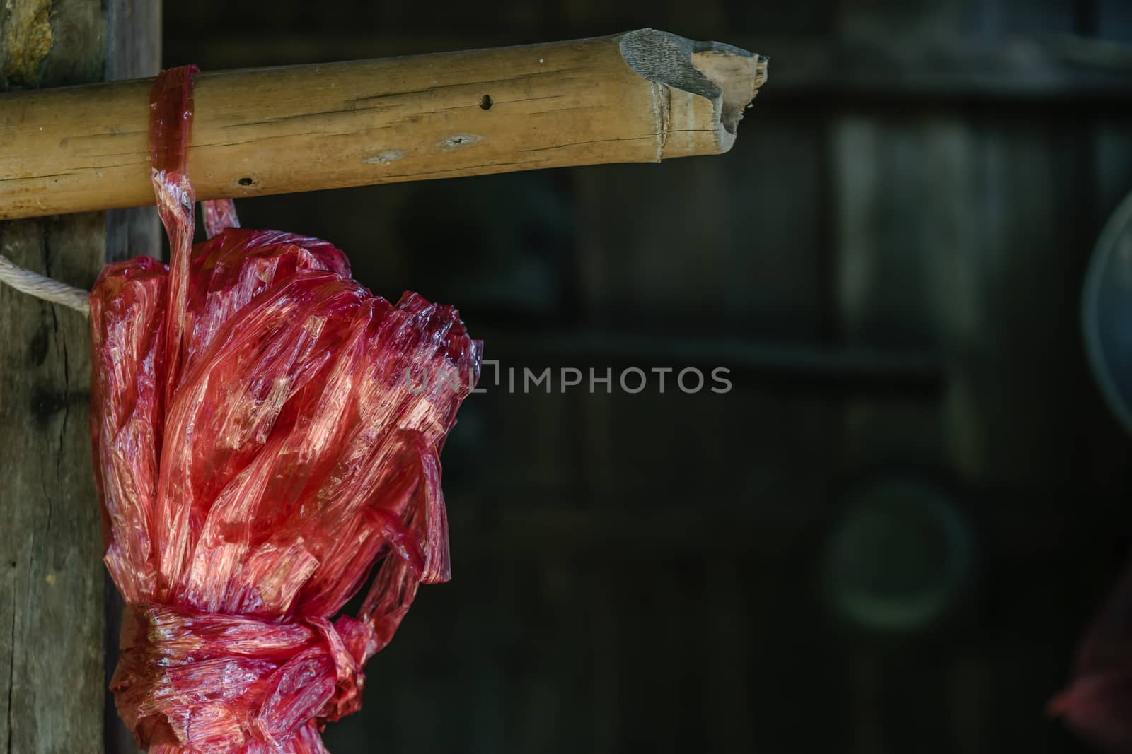 Red plastic rope rope on blur barn background
