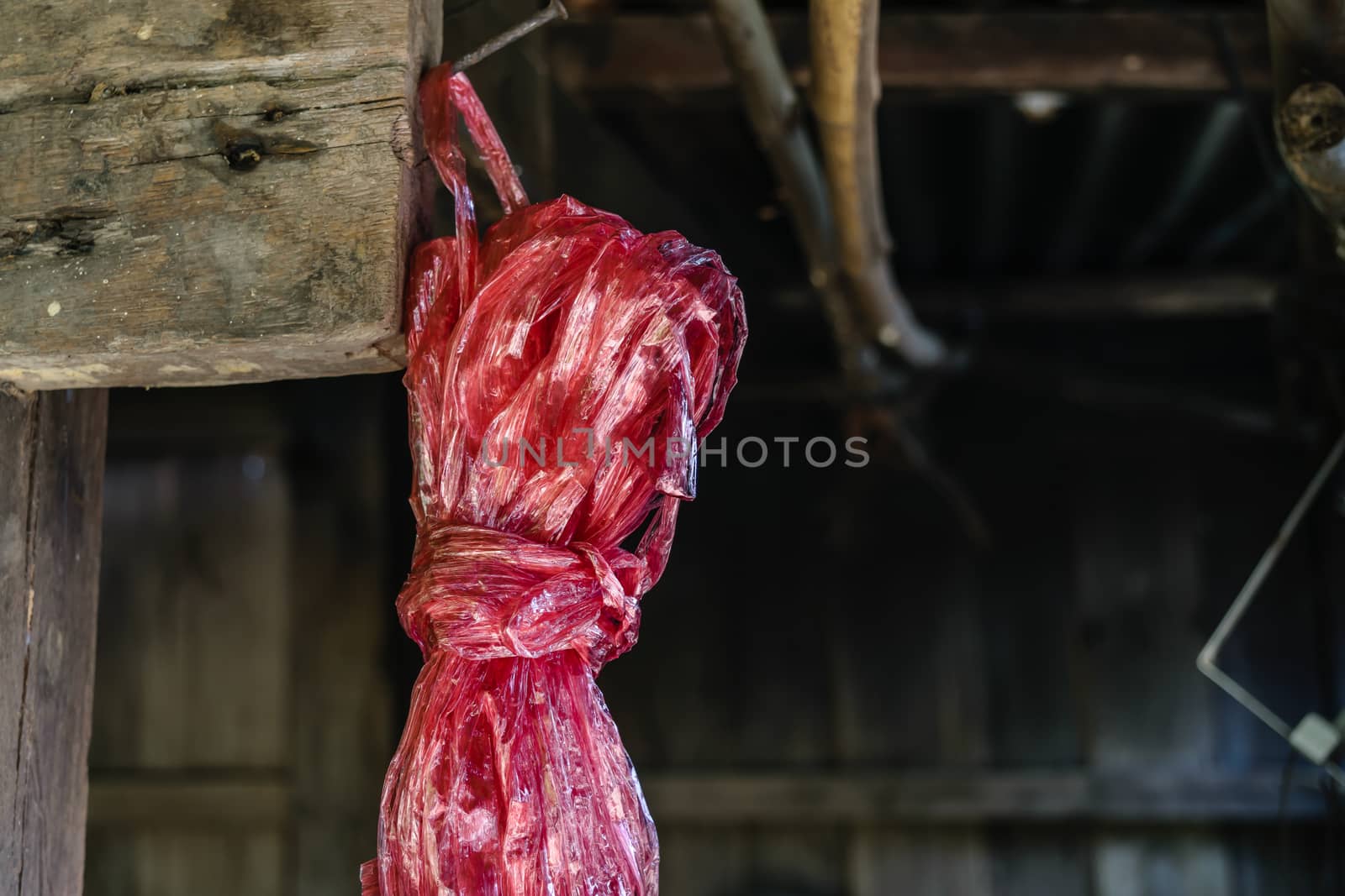 Red plastic rope rope on blur barn background