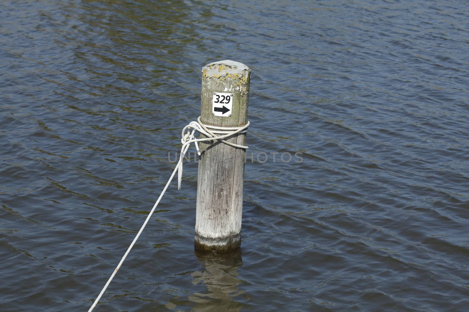 wooden peg with rope in a harbour