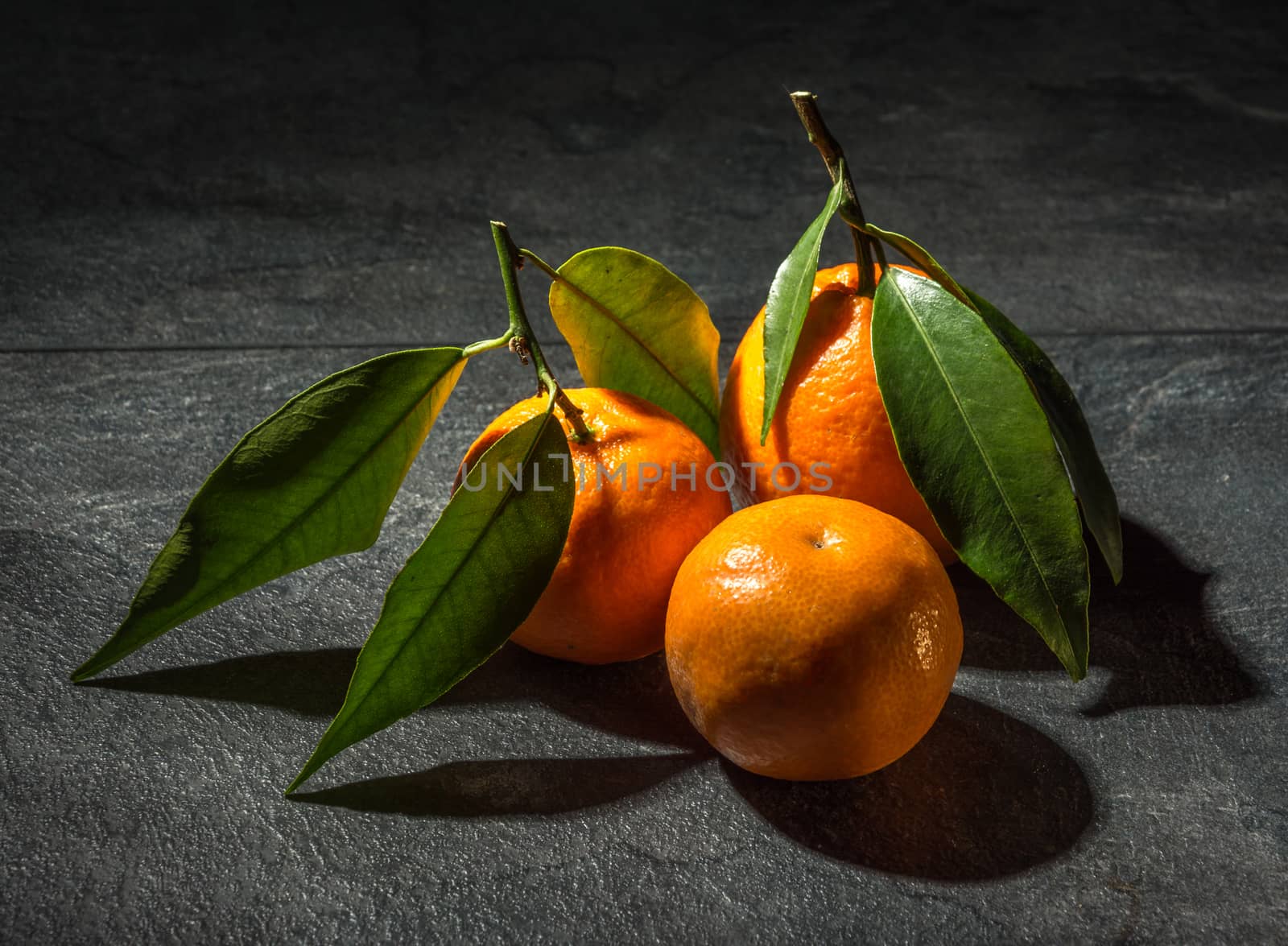 Delicious and rich in vitamins tangarines on a dark table