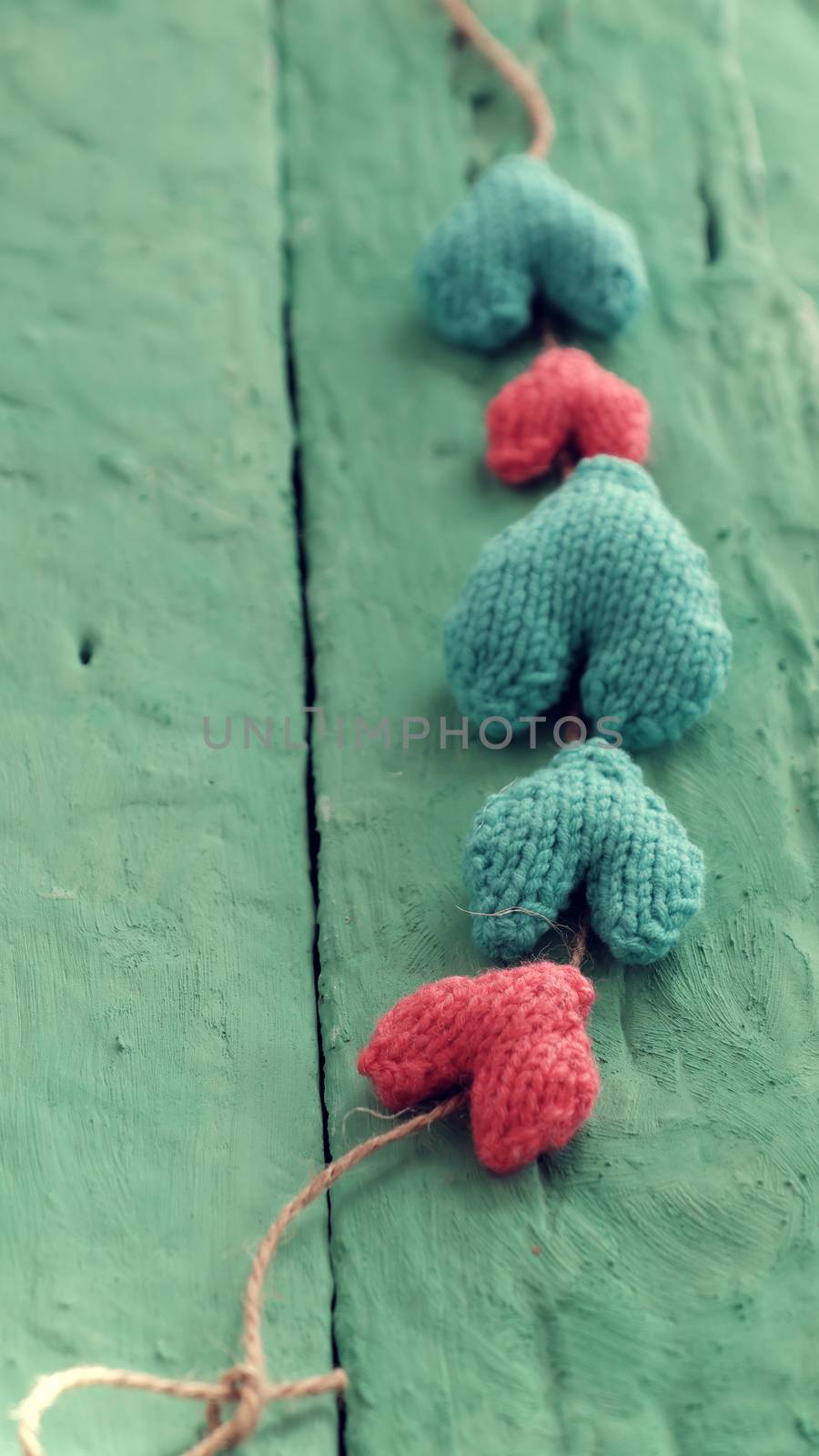 Group of valentine background with red and green heart on green wooden in vintage color, knitted heart is symbol for romantic love of couple in feb 14