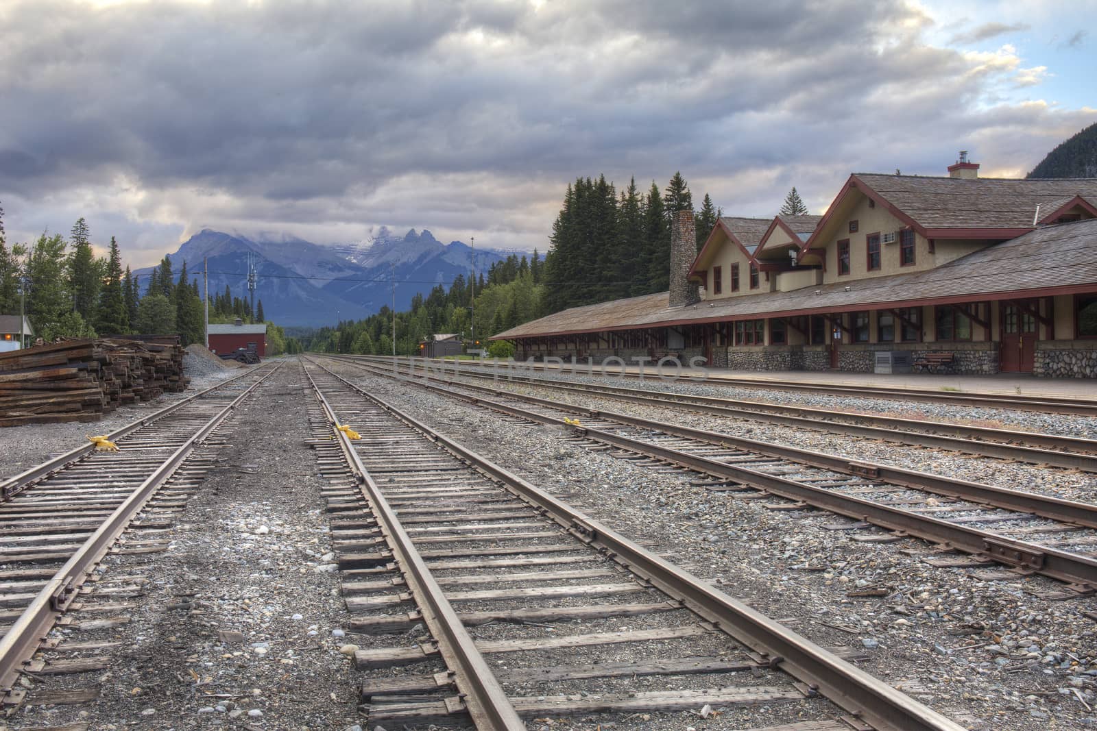 Railway tracks run past the historic Banff Train Station - Banff, Alberta, Canada