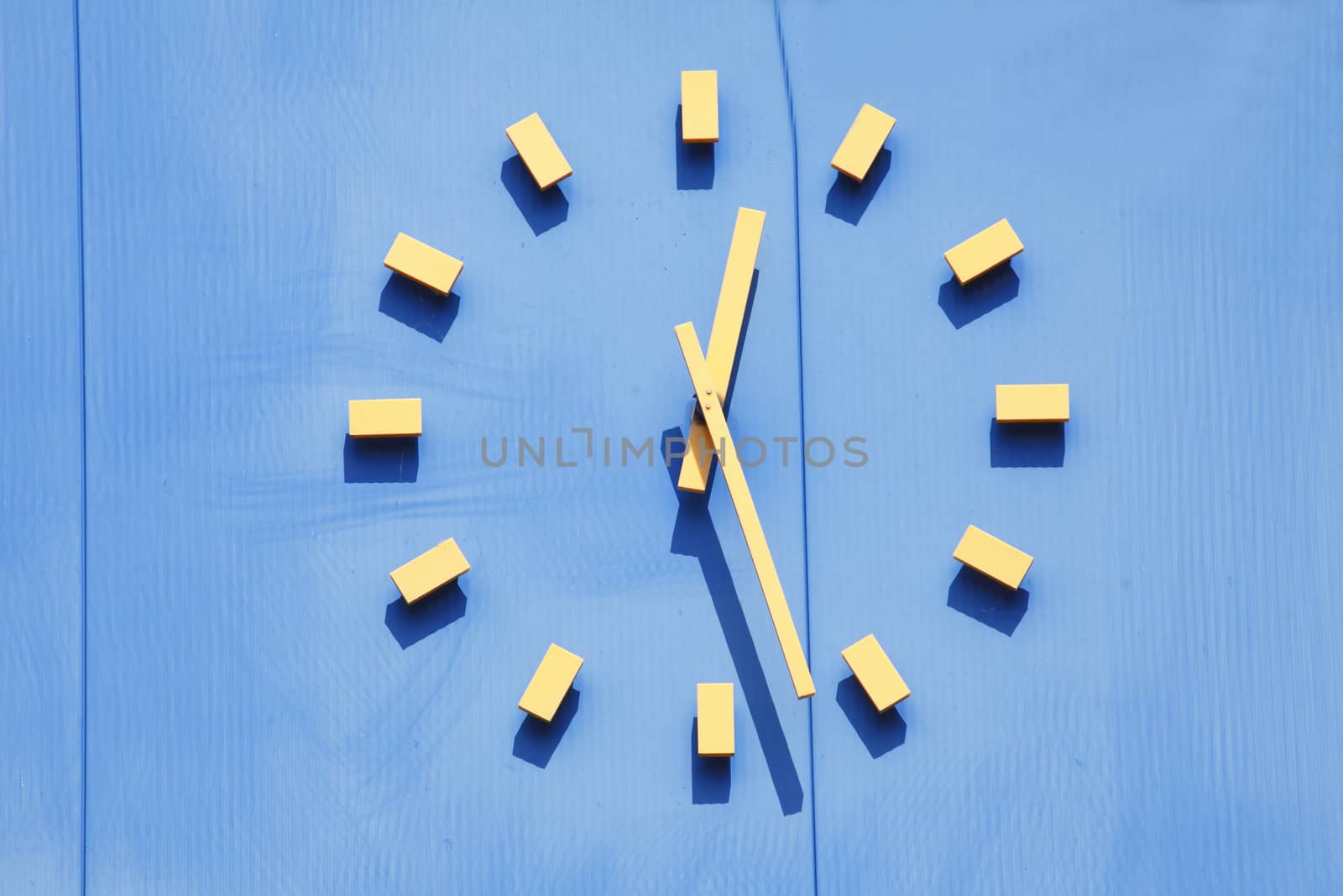 Yellow clock on a Blue Wall