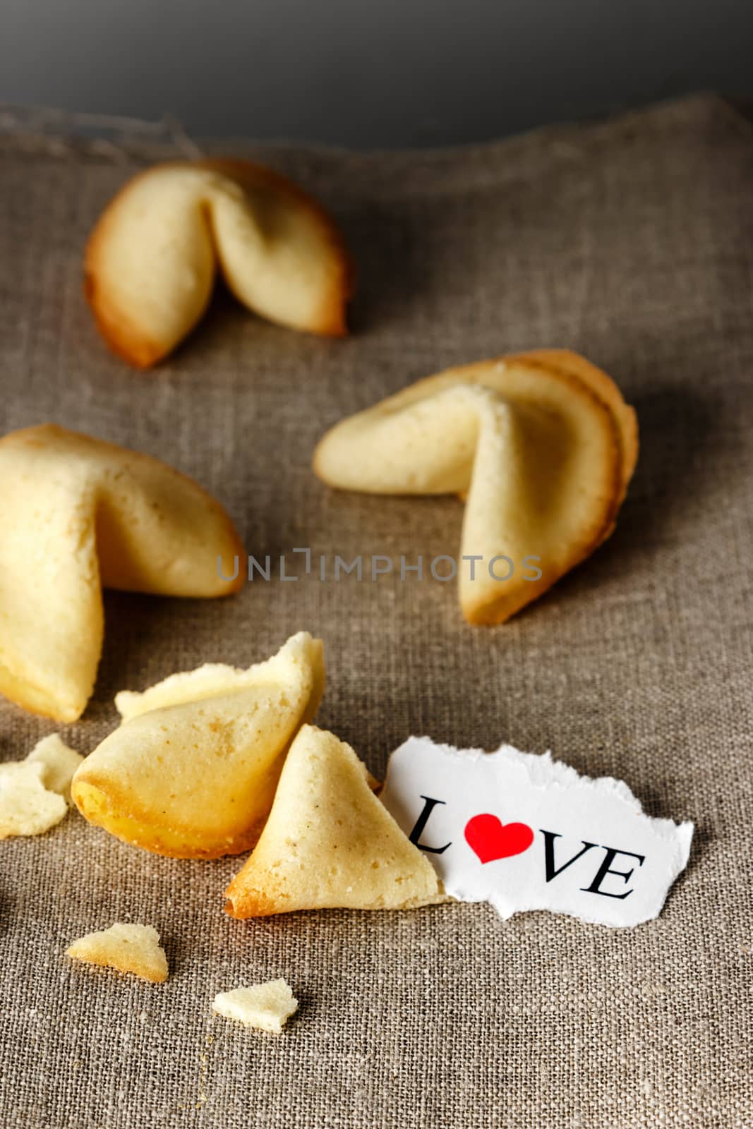 Cookies shaped like tortellini with the word love written on a paper.Vertical image.