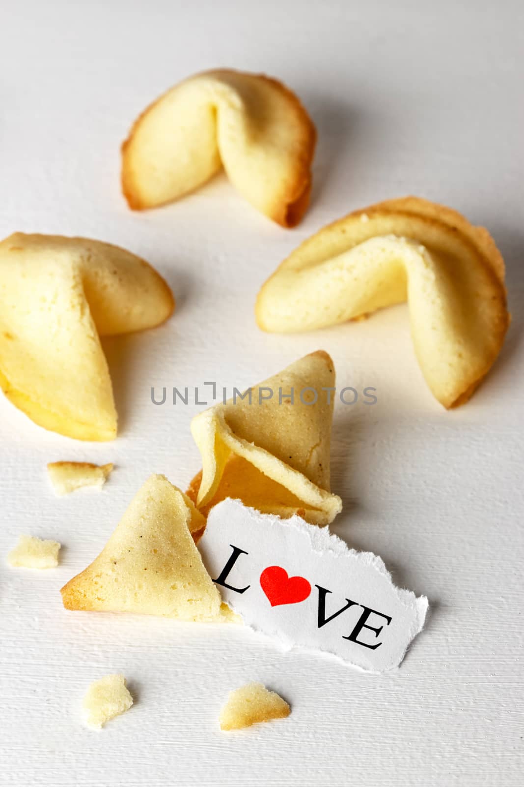 Cookies shaped like tortellini with the word love written on a paper.Vertical image.