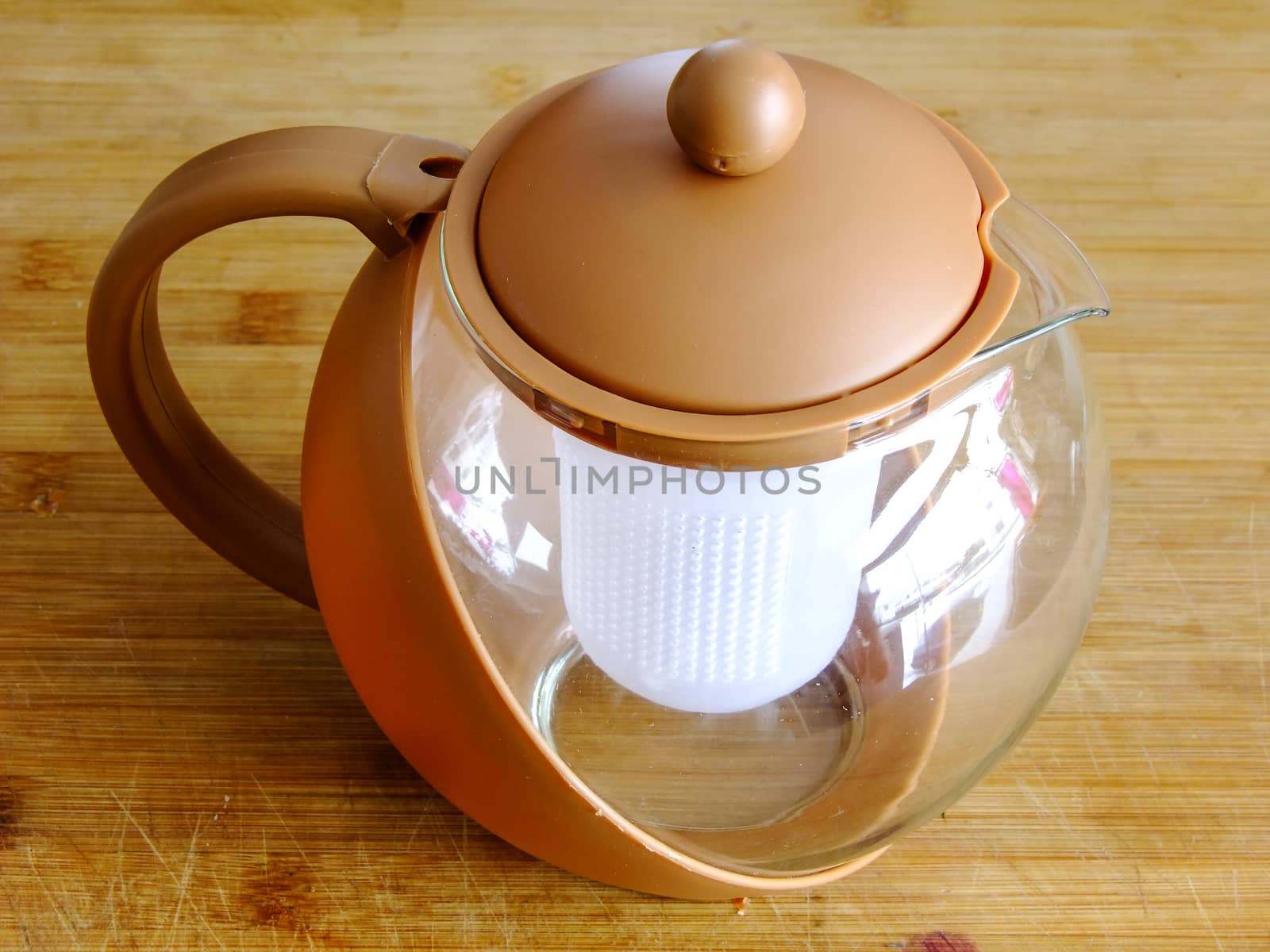 Brown Teapot on wooden Cutting Board by stragys