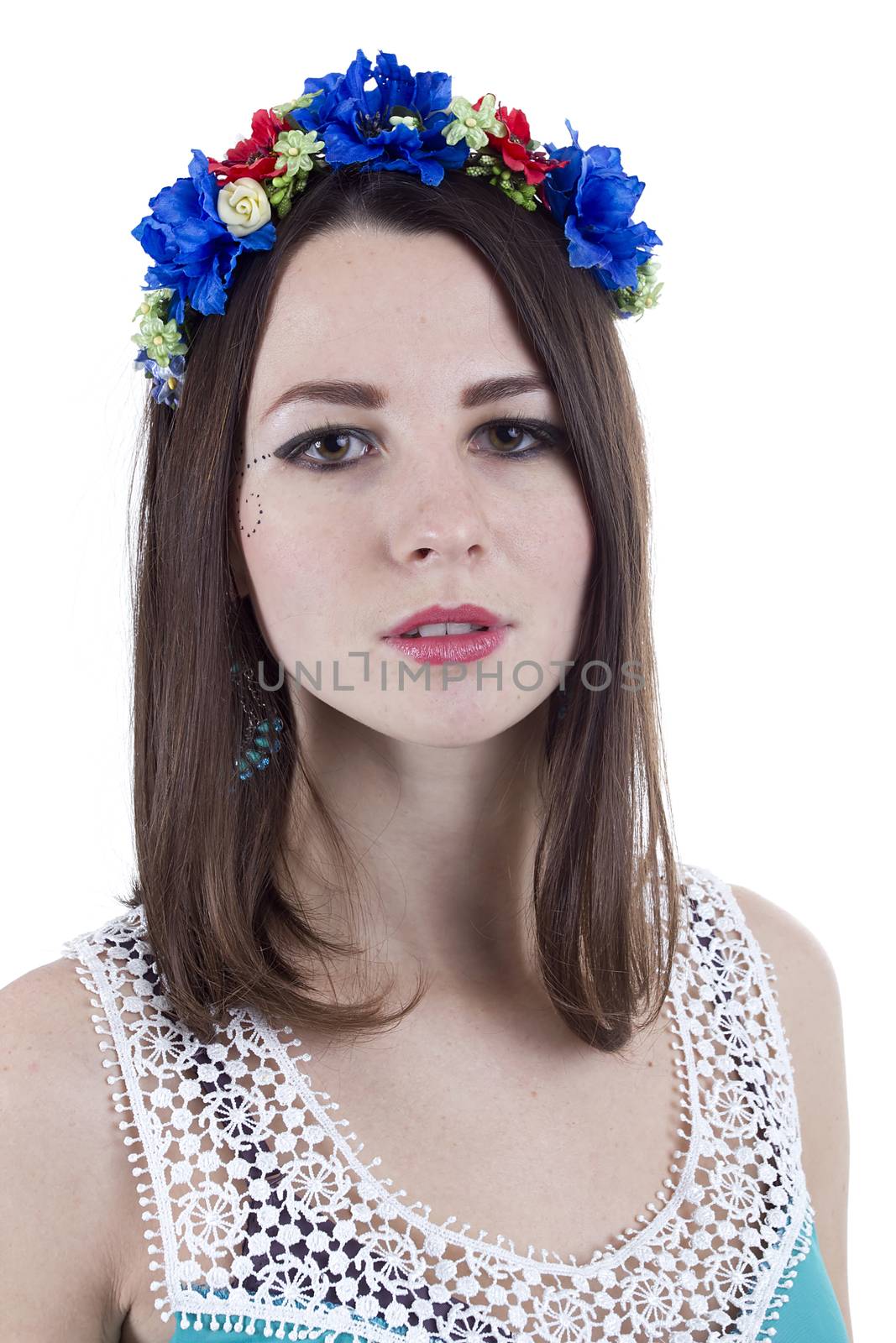 Portrait of a girl in a wreath of flowers on a white background