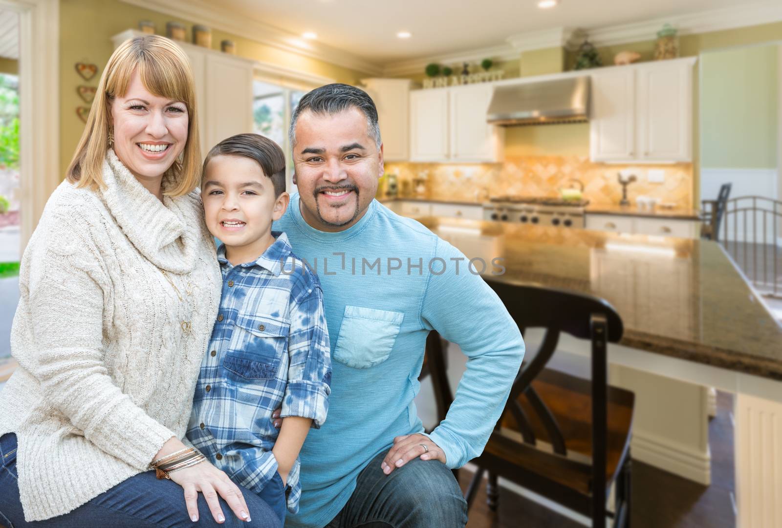 Happy Mixed Race Young Family Inside Beautiful Kitchen of Their House.