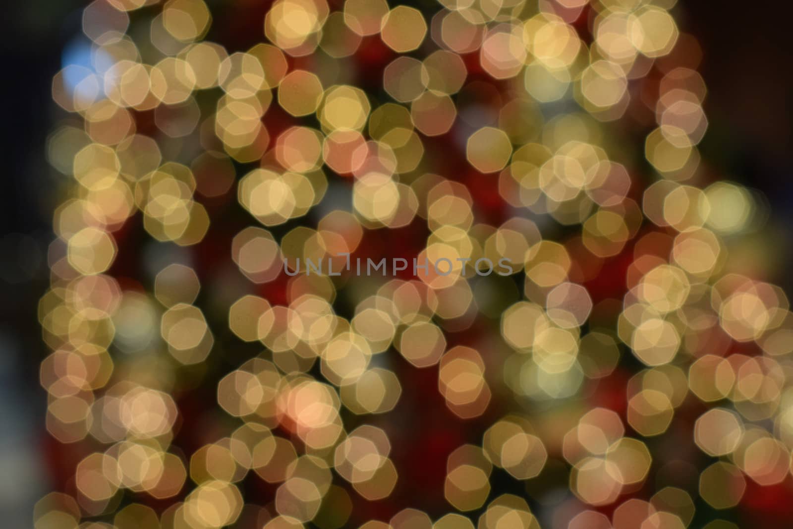 Holiday background - Large Christmas tree blurred lights in horizontal frame