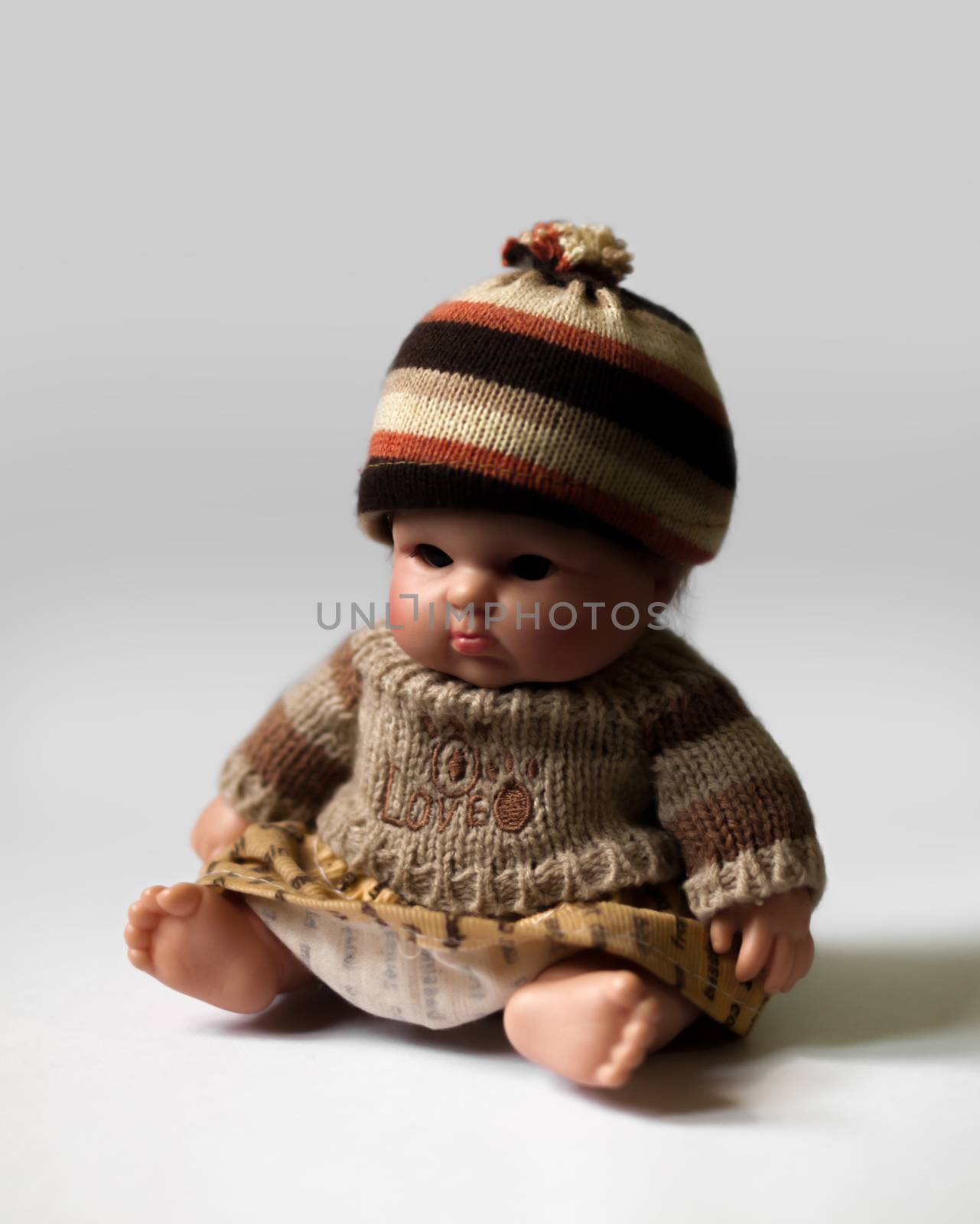 COLOR PHOTO OF SITTING DOLL